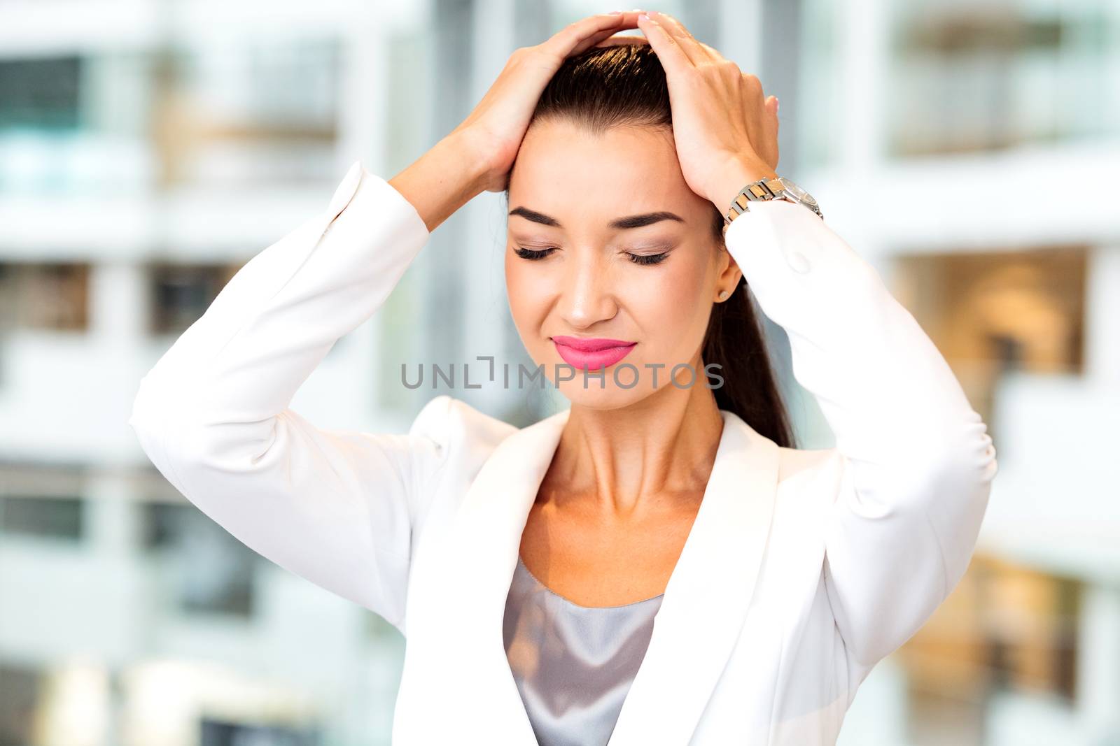 Woman with a headache in an office. Woman forgot something.