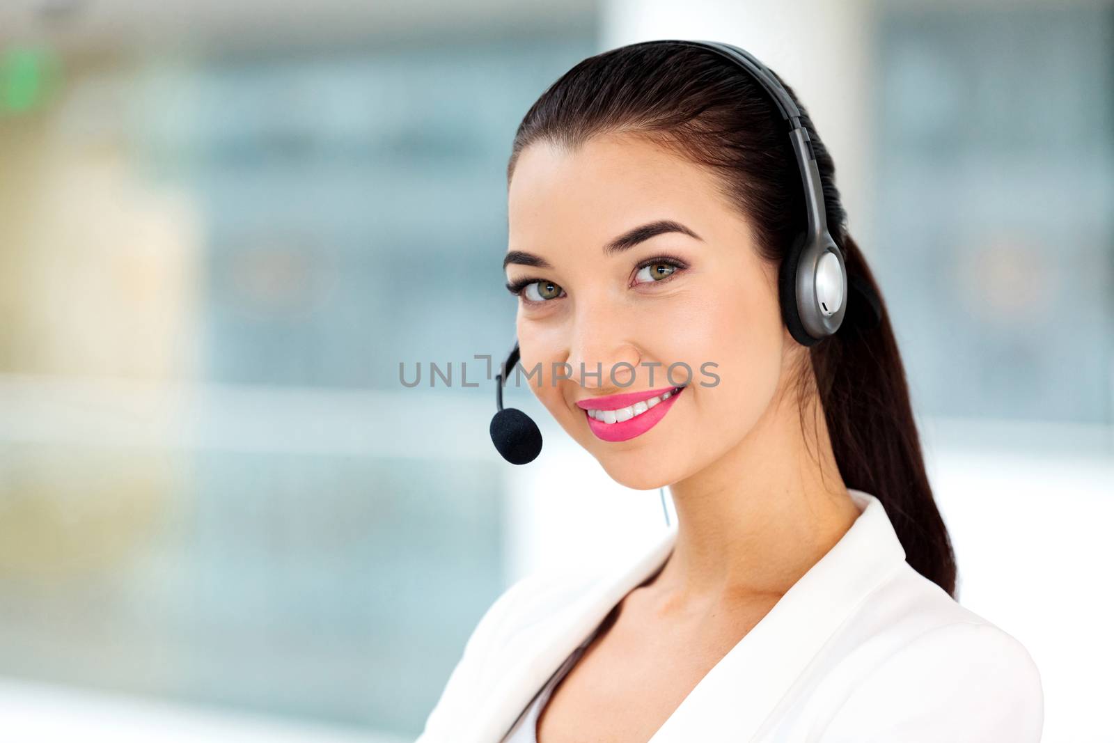 Closeup portrait of support phone operator in headset at workplace