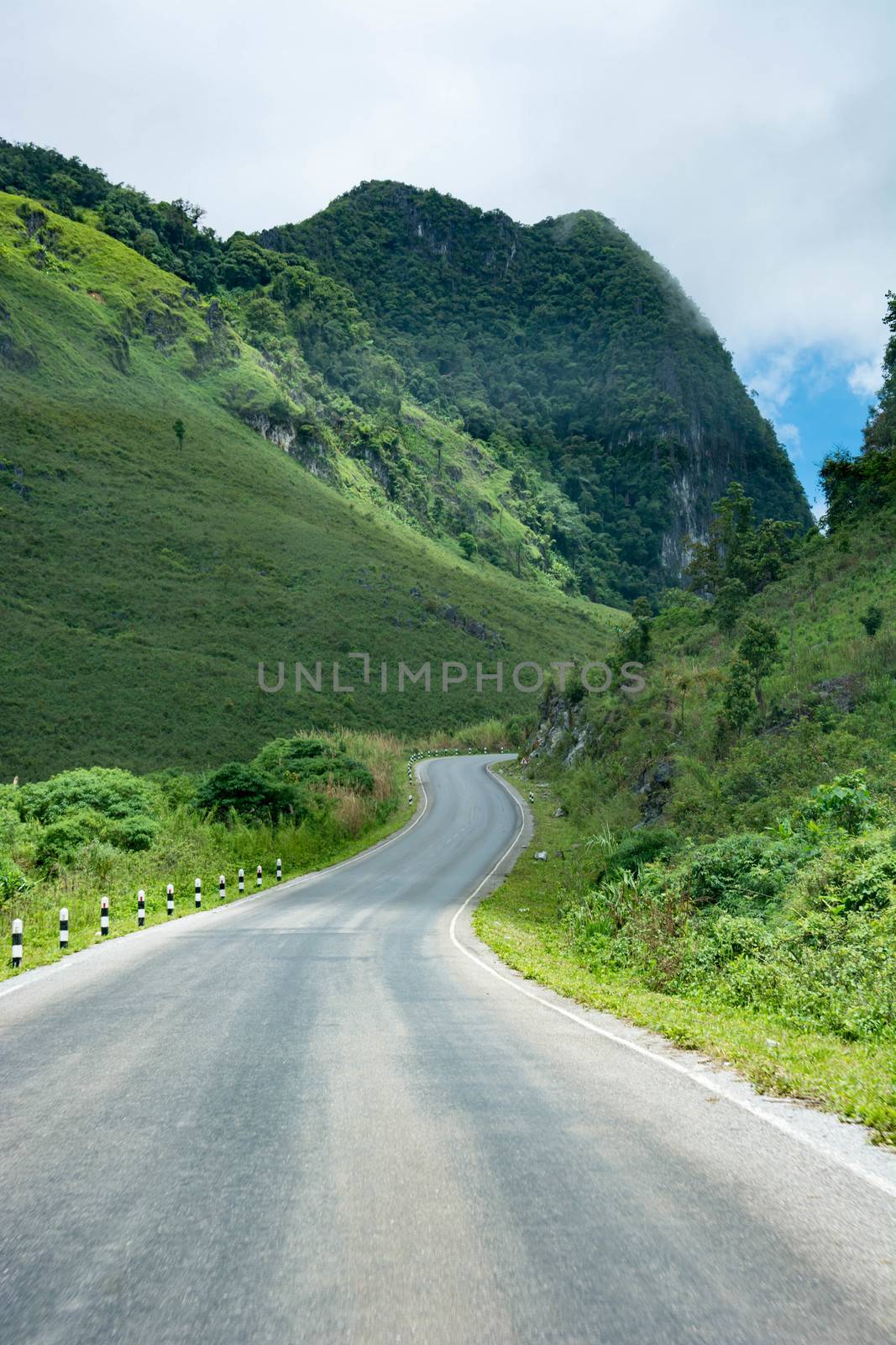 Long And Winding Rural Roads Leading Through Green Hills In Laos, The Route Between Vang Vieng - Luang Prabang