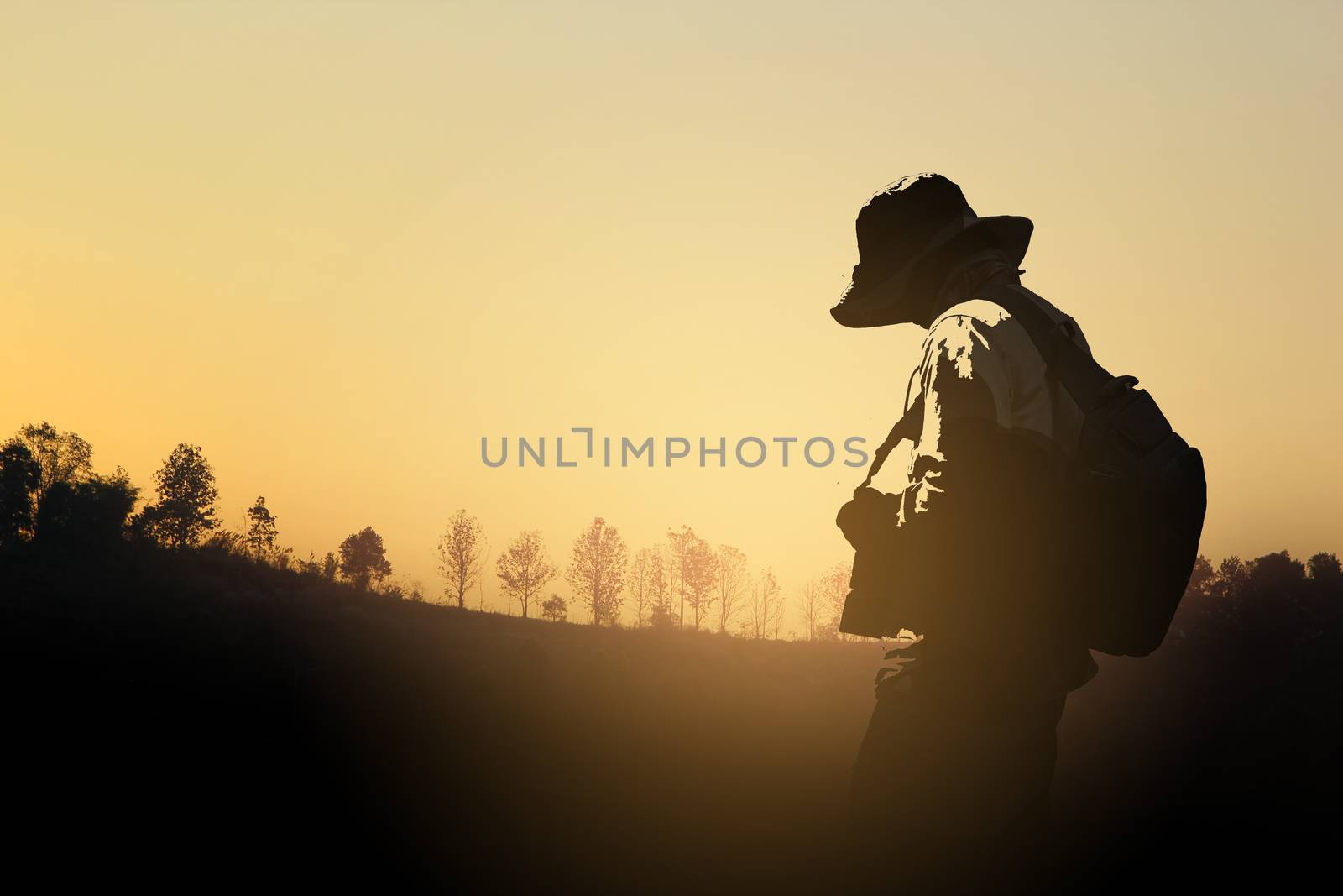 Silhouette Of Camera Man Standing At Forest In Sunset