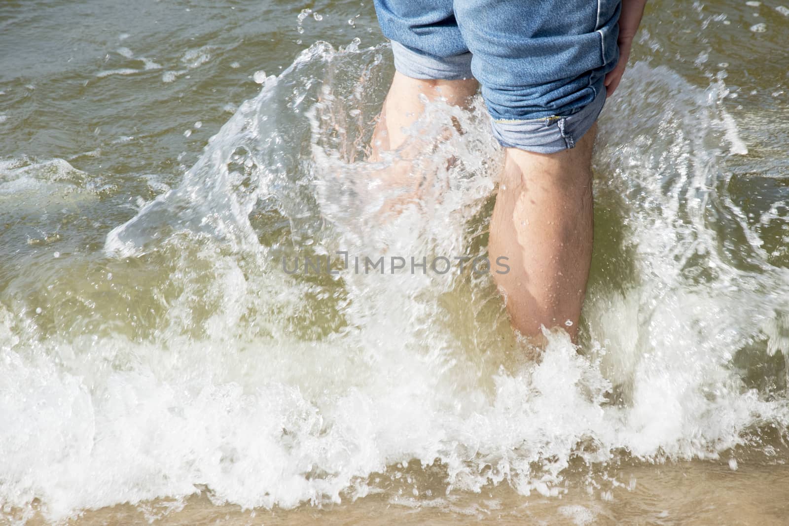 legs in wave sea photo. Beautiful picture, background, wallpaper 
