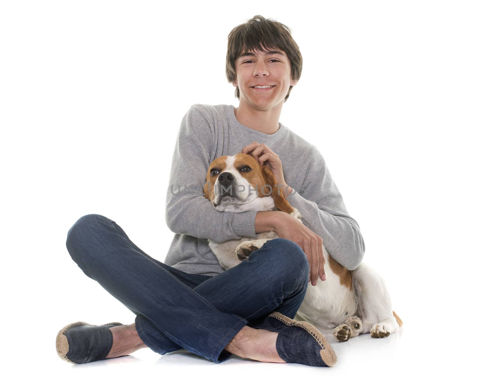 adult beagle and teenager in front of white background