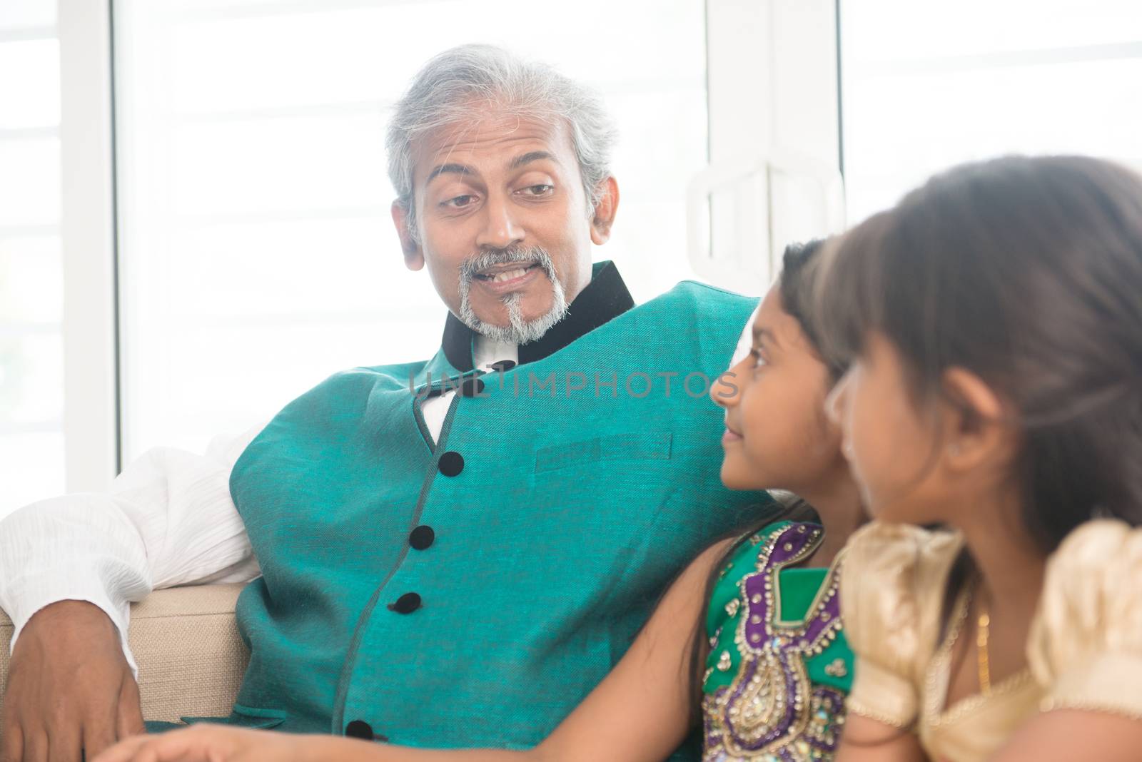Portrait of Indian family at home. Happy Asian father and children indoors lifestyle.