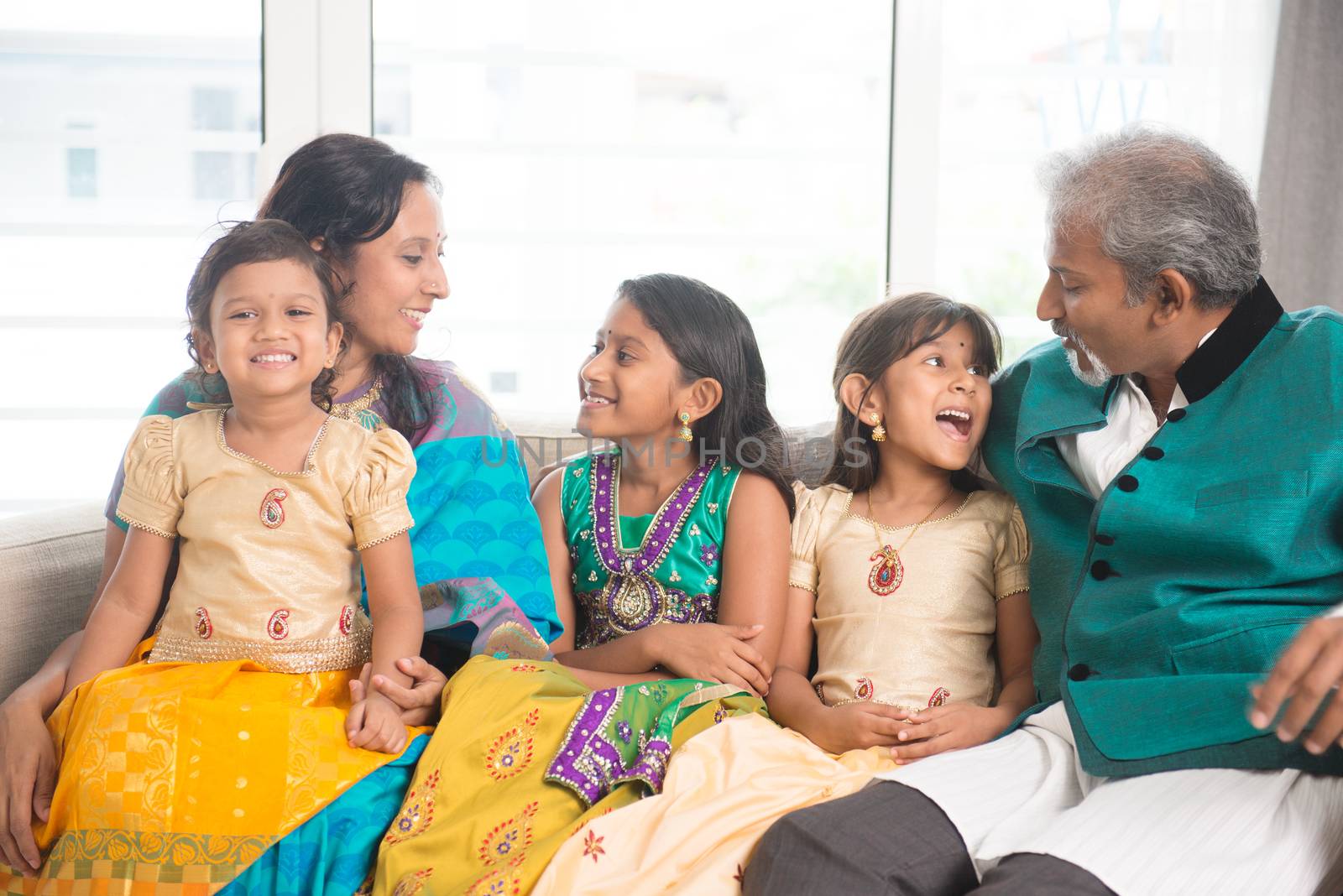 Portrait of happy Indian family having fun at home. Asian parents and children indoors lifestyle.