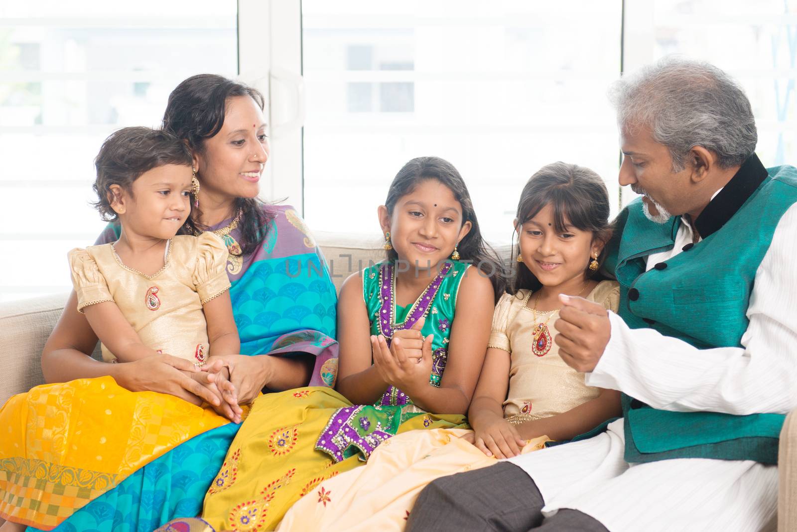 Happy Indian family indoors by szefei