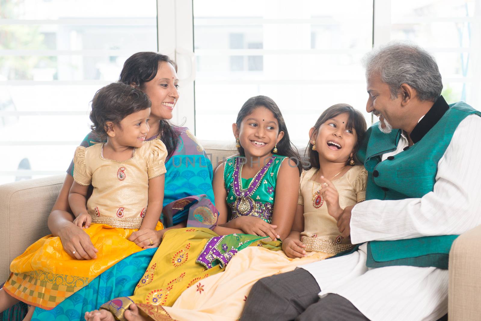 Portrait of happy Indian family bonding at home. Asian people indoors lifestyle.