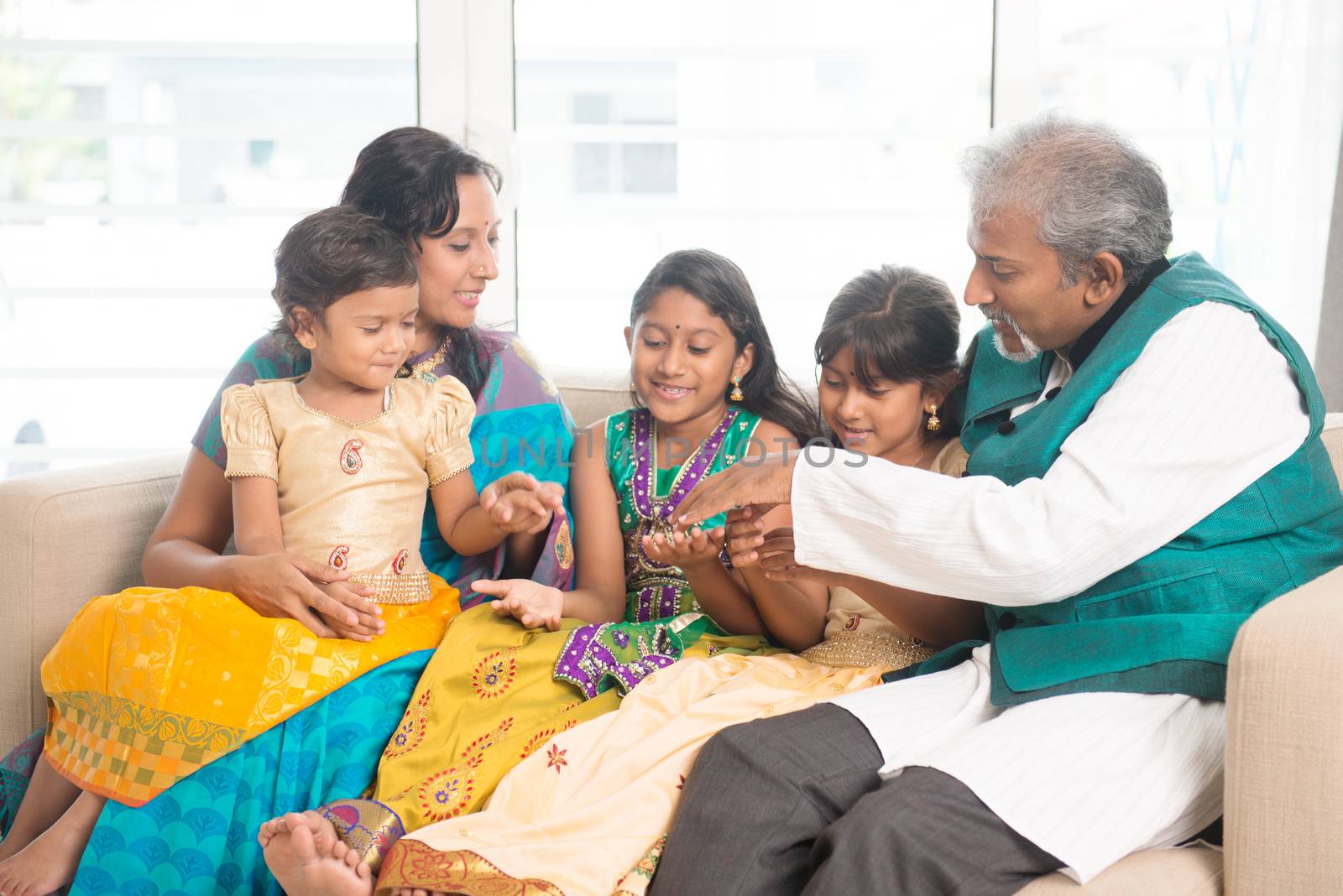 Portrait of happy Indian family having fun at home. Asian people indoors lifestyle.