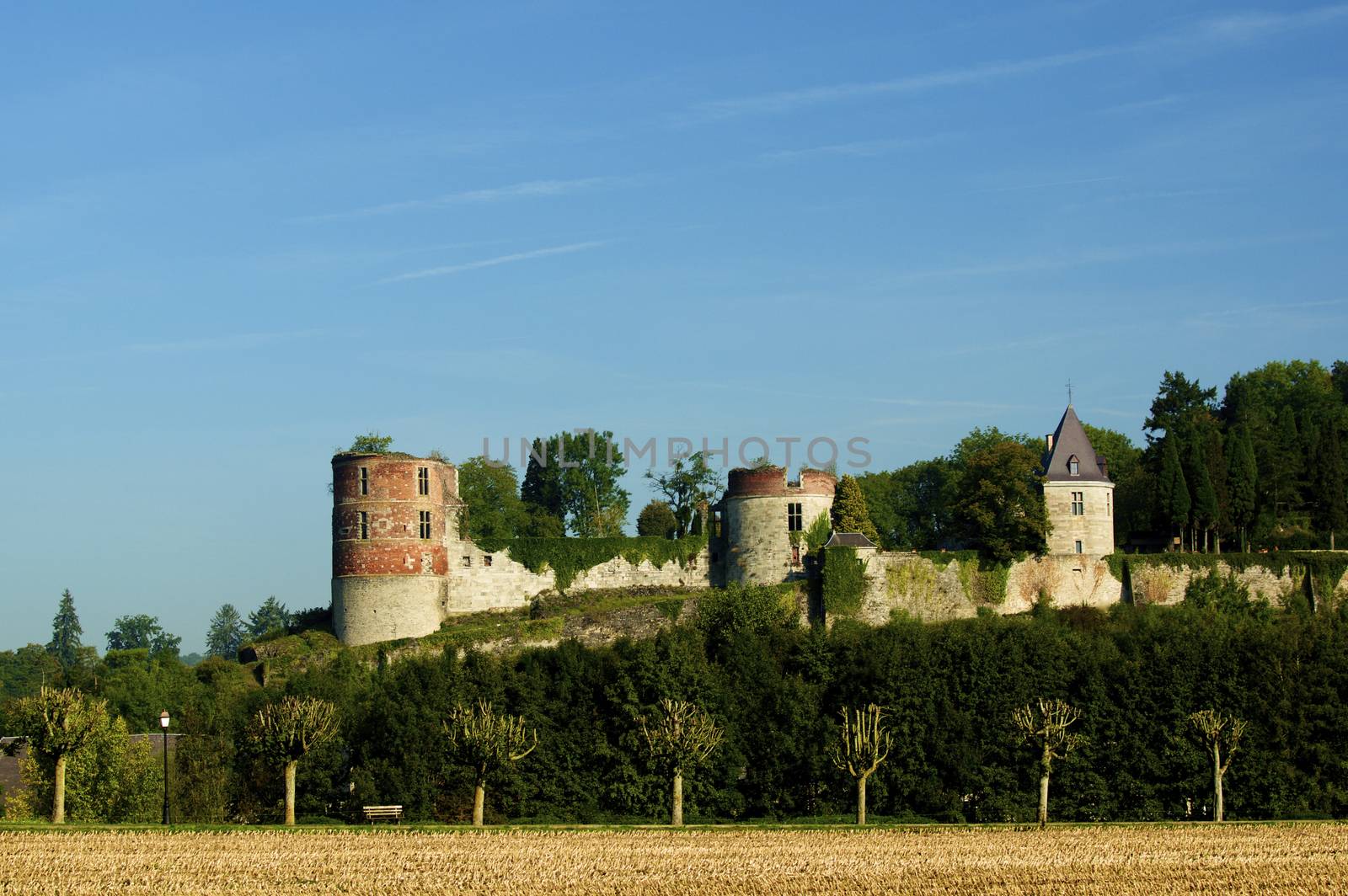 Castle of Hierges - Château de Hierges - with Tree Alley on Blue Sky background Outdoors. Ardennes region of France