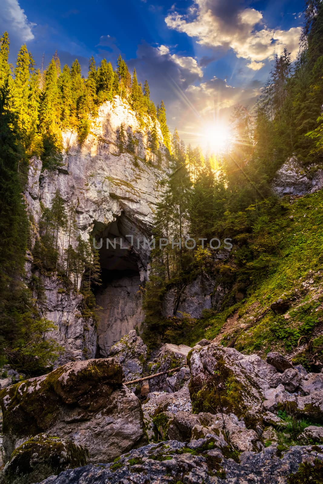 Cetatile cave sculpted by river in romanian mountains at sunset by Pellinni