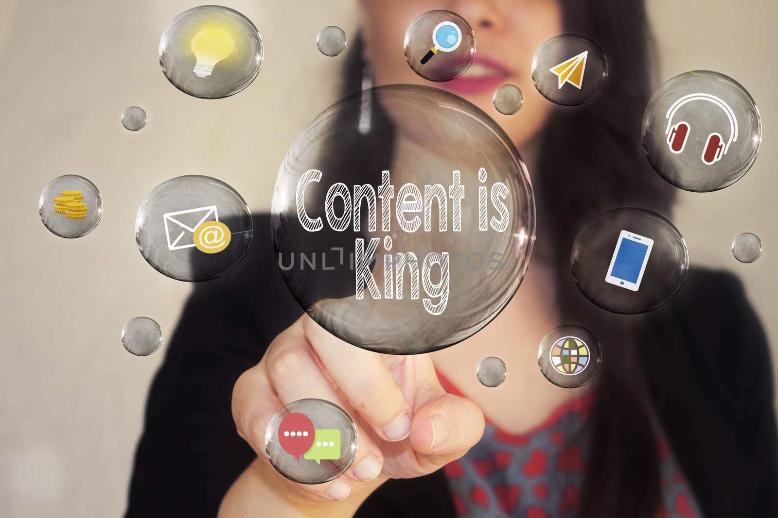 Portrait of a beautiful young woman pointing her finger to Content is king in transparent bubble