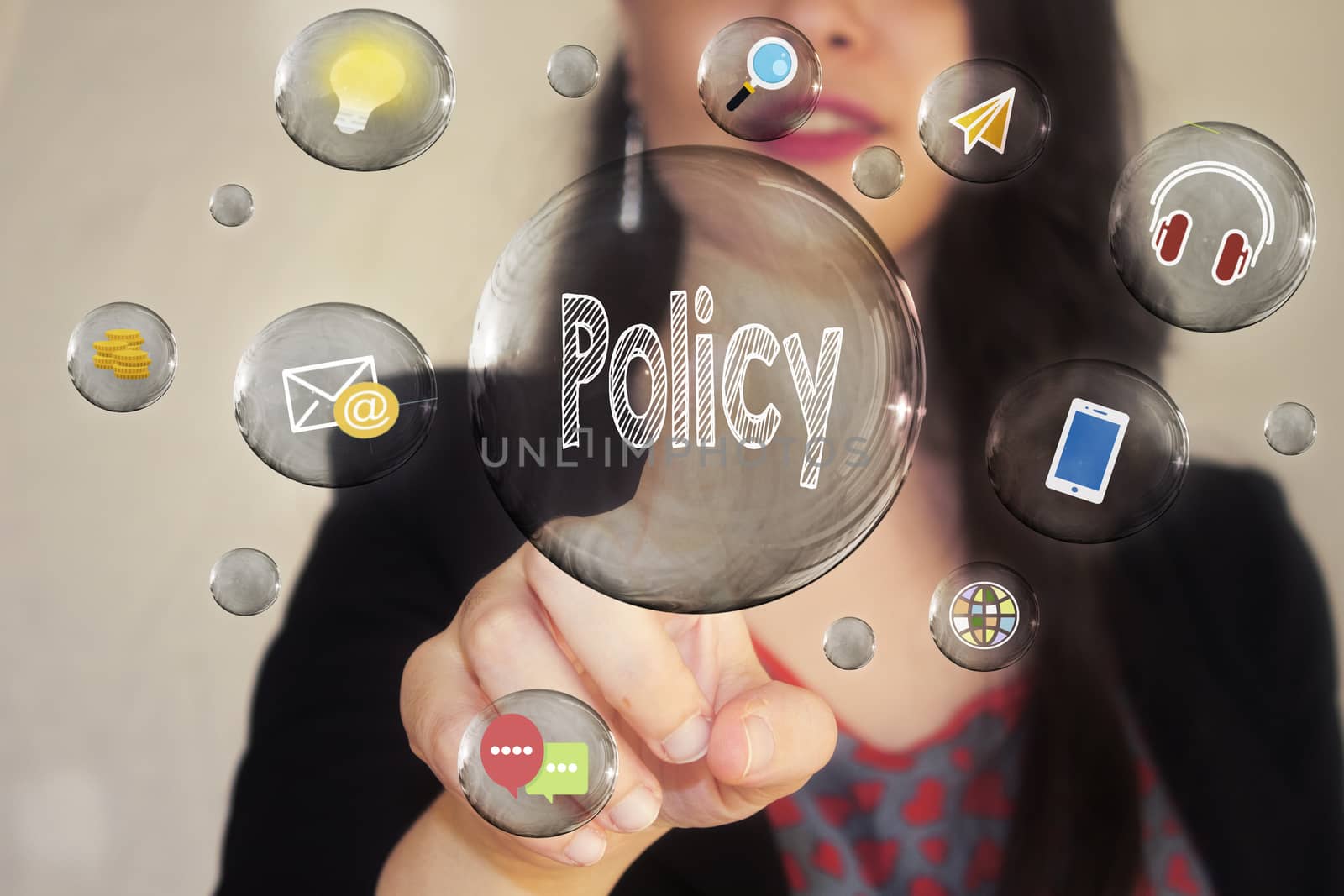 Portrait of a beautiful young woman pointing her finger to Policy in transparent bubble