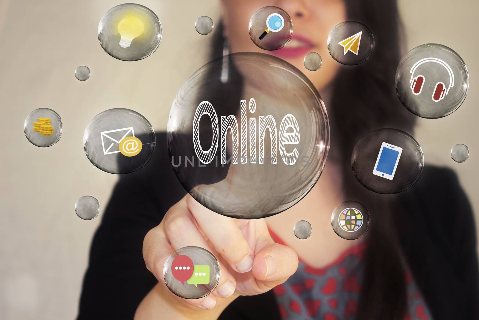 Portrait of a beautiful young woman pointing her finger to Online in transparent bubble