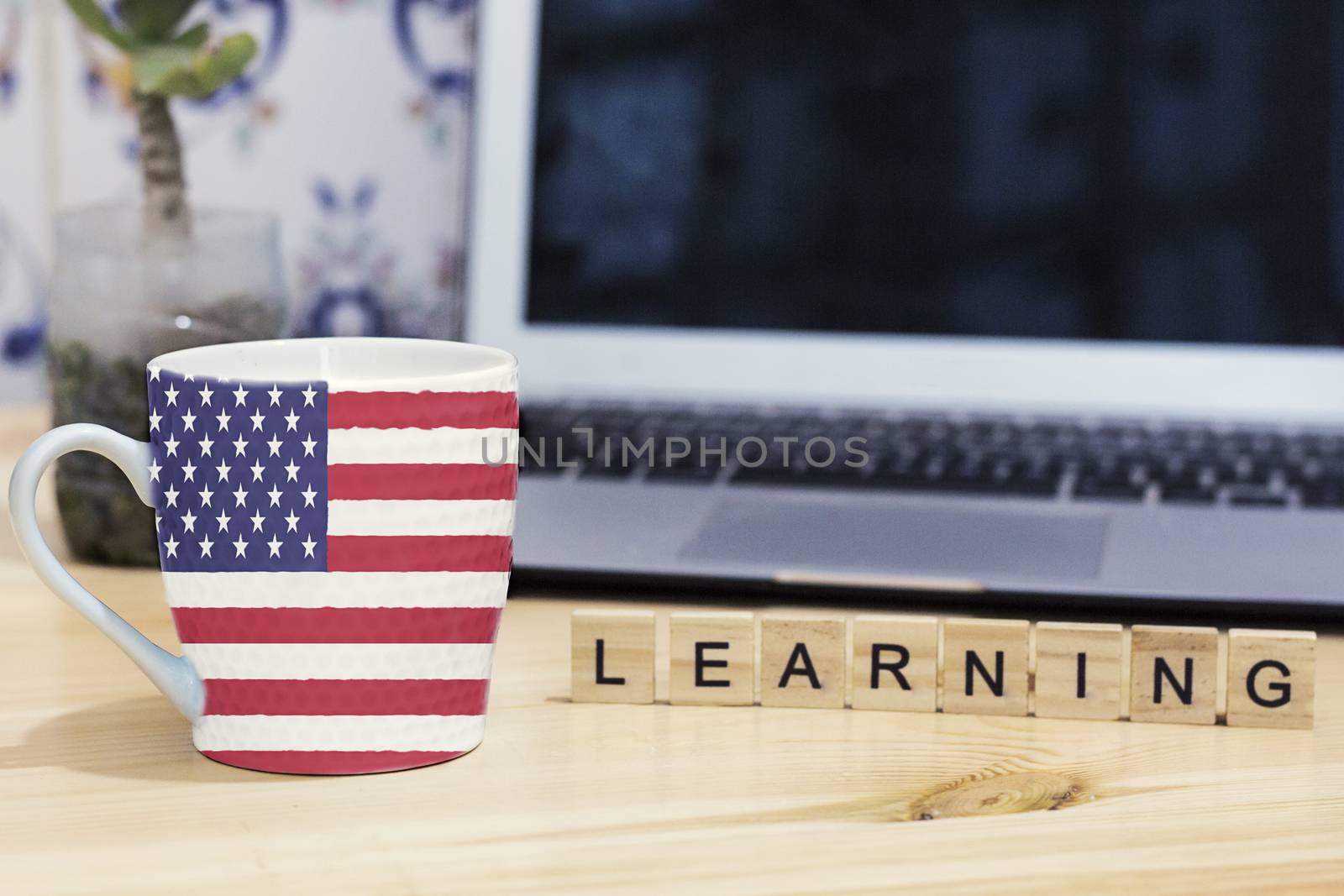 English ,usa flag painted on cup coffee, letter wood learning,gray laptop