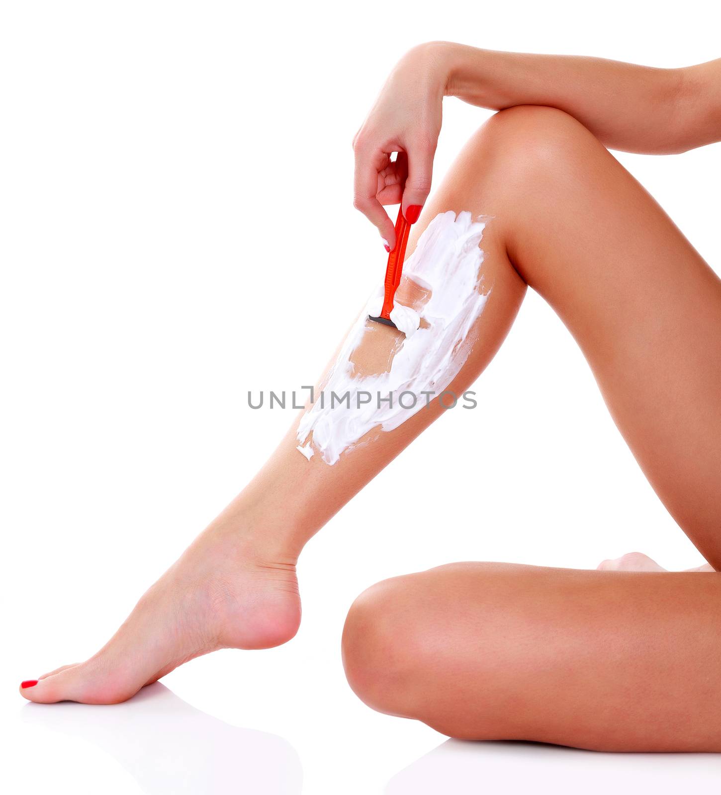 Woman shaves her leg, isolated on white background