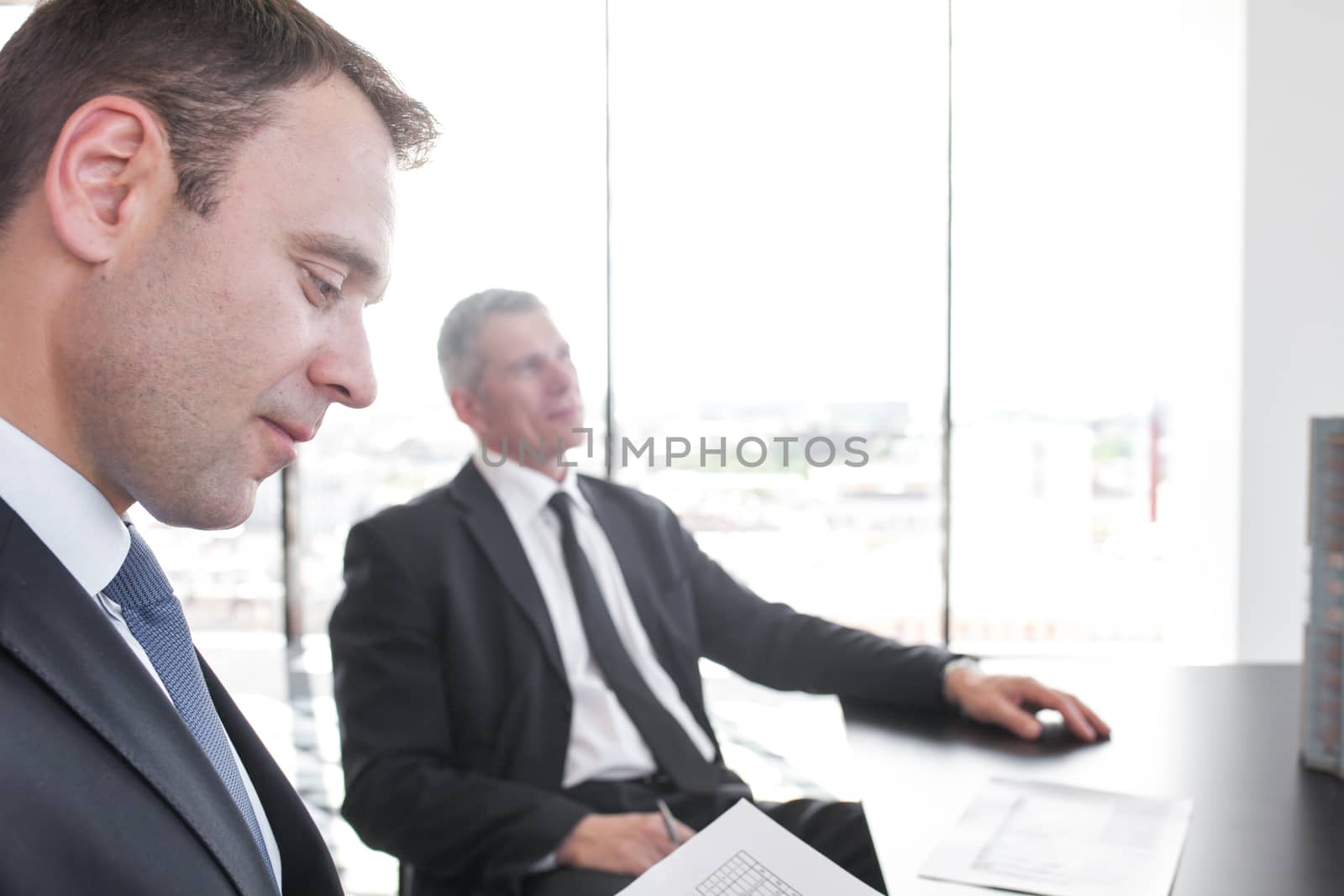 Close-up portrait of thougtful business man at meetig in office