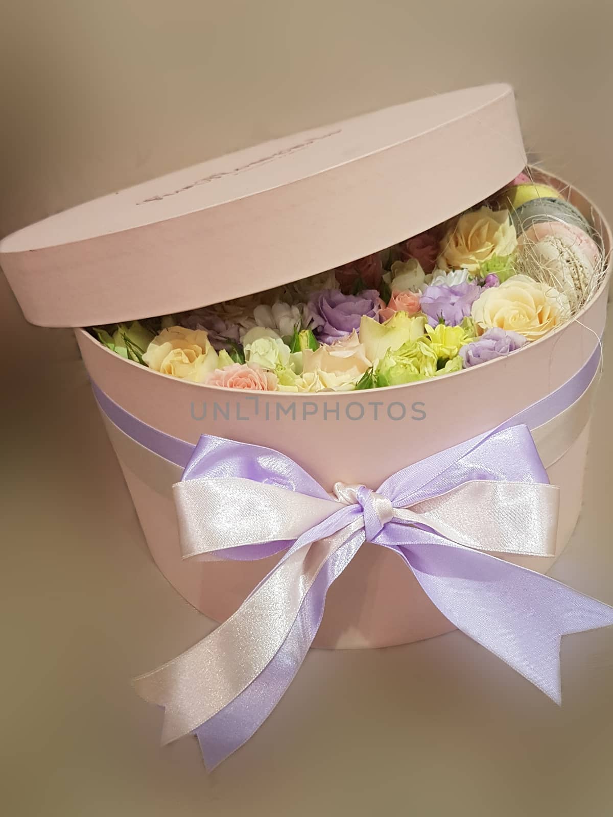 large box with buds of roses of different colors, a soft light background. A gift on Valentine's Day February 14
