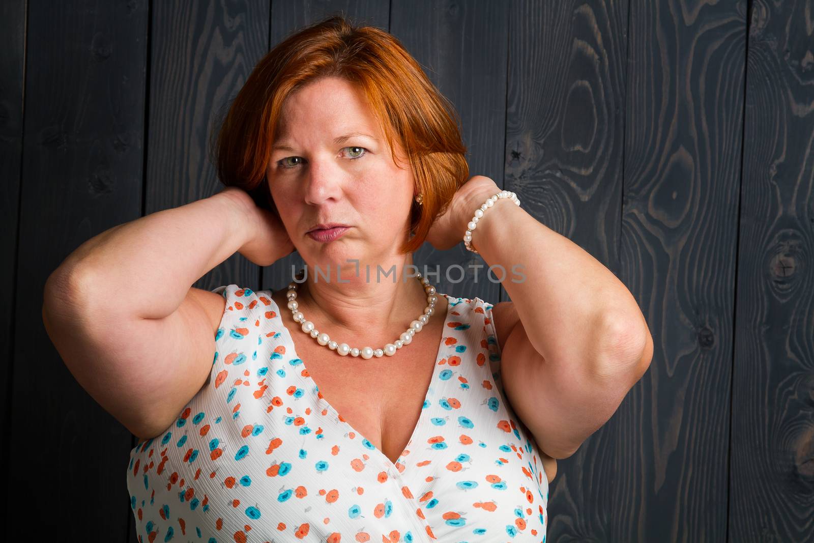 round red hair woman fluffing her hair