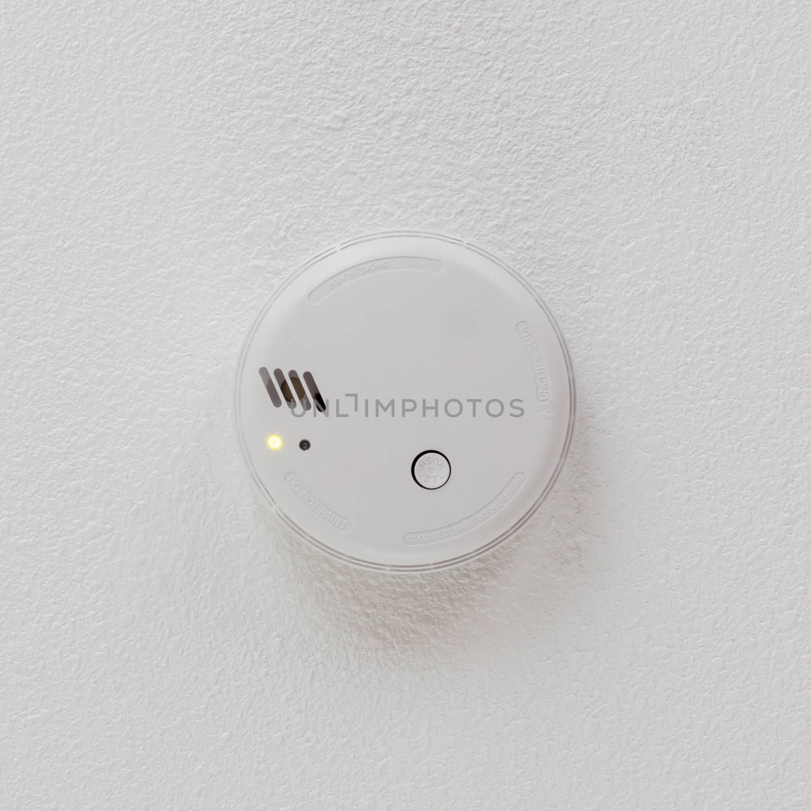 Smoke detector hanging on a ceiling - Private home