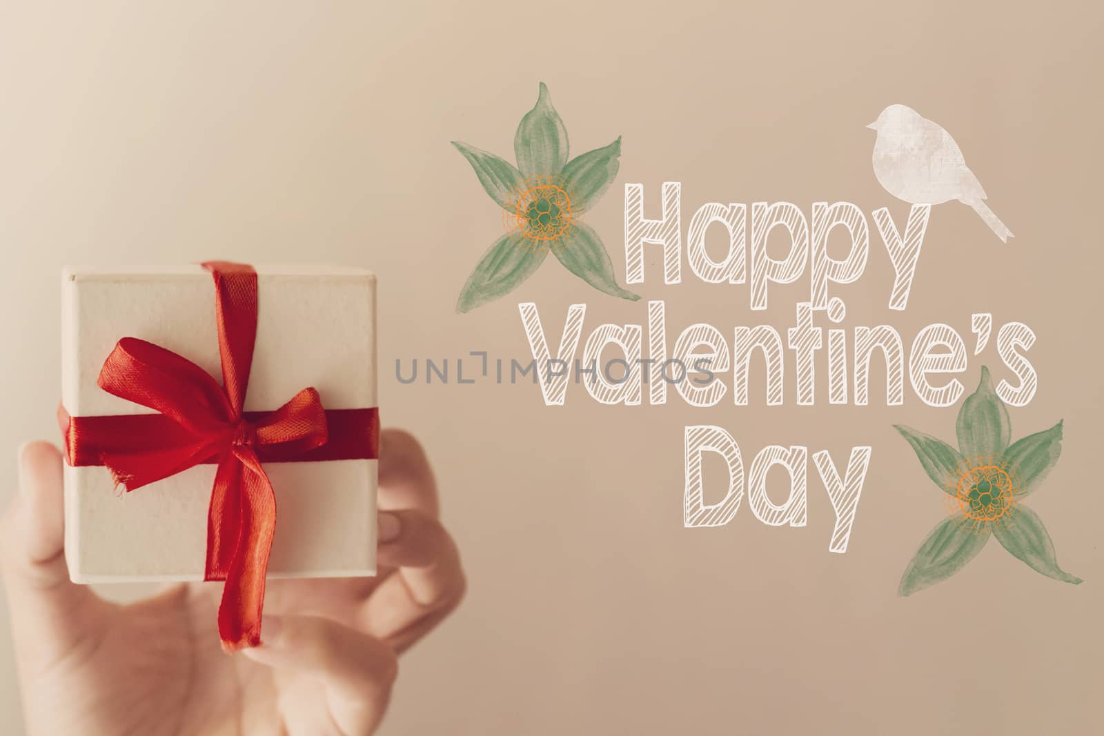 Happy Valentine's day message with white gift box with red ribbon hold on hand woman