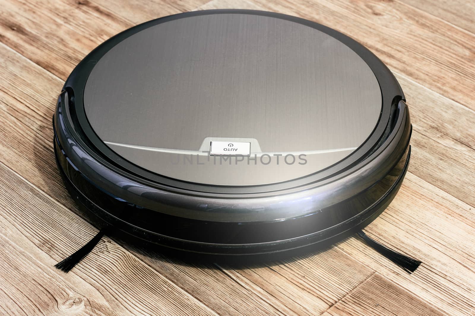 robot vacuum cleaner on the parquet floor in the apartment