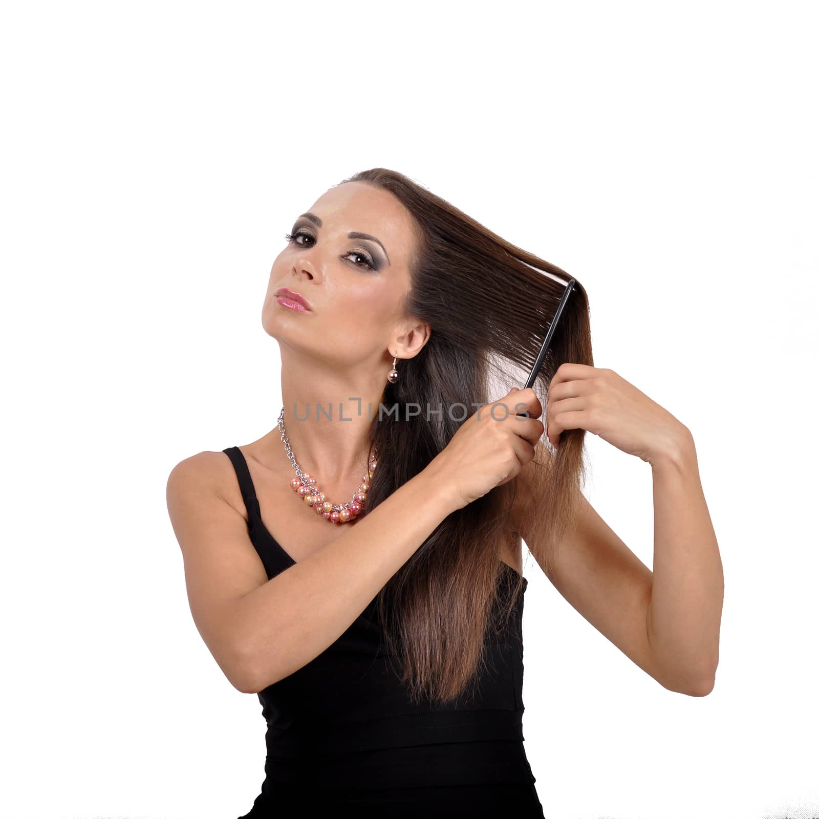 Beautiful young woman brushing her hair hairbrush by Nikola30
