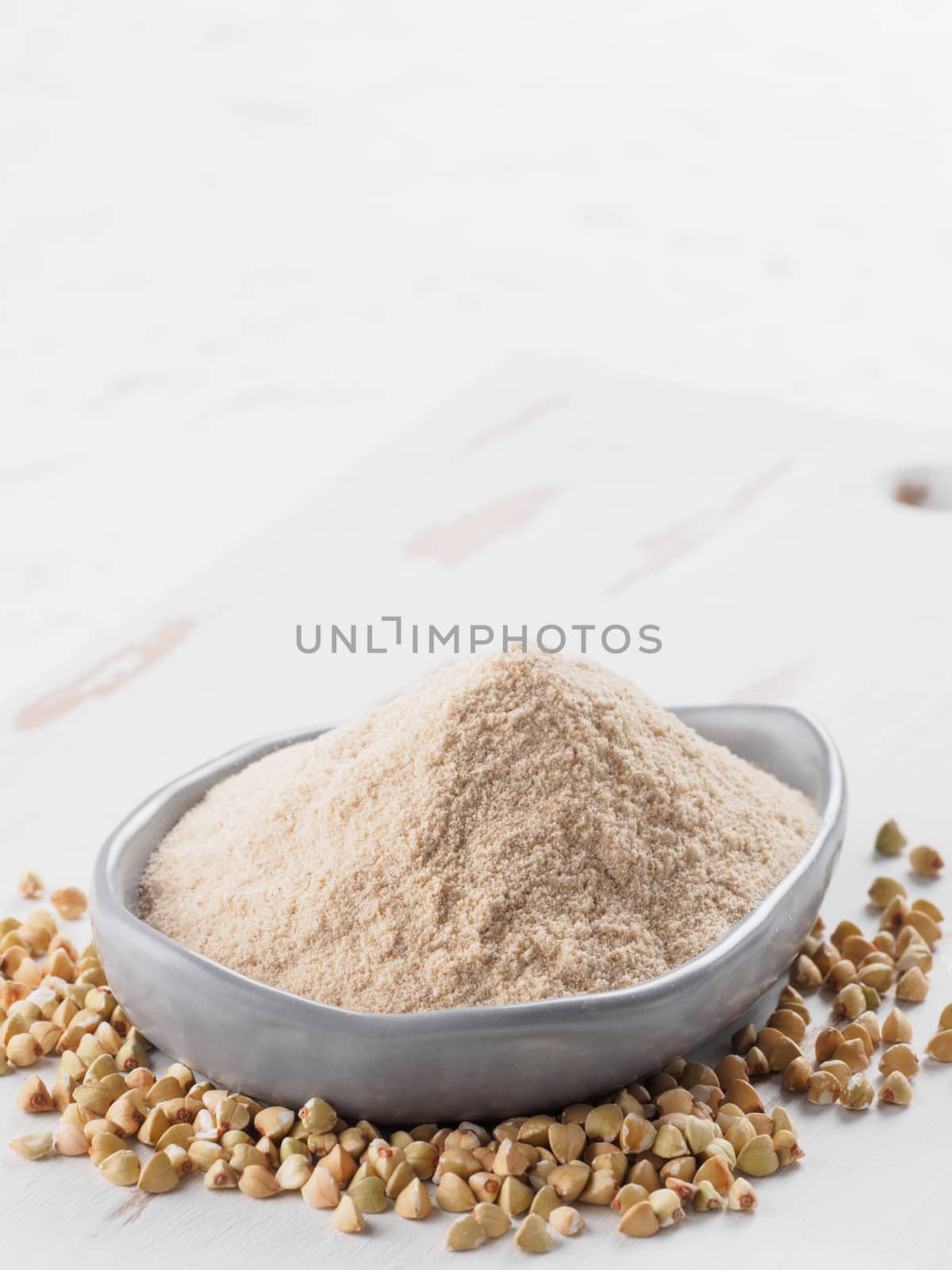 Buckwheat flour and buckwheat on white background Copy space.