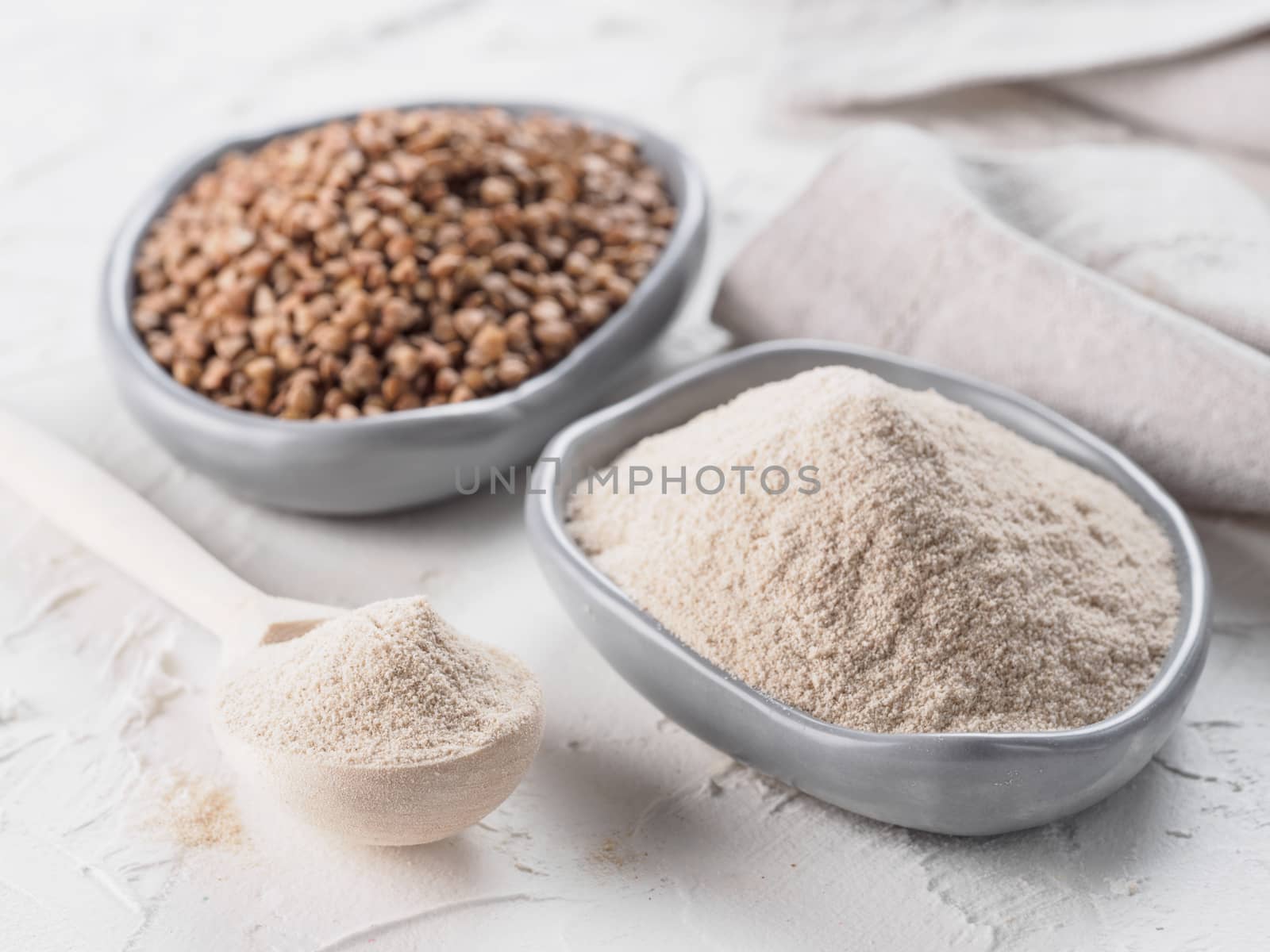 Buckwheat flour and buckwheat on white background