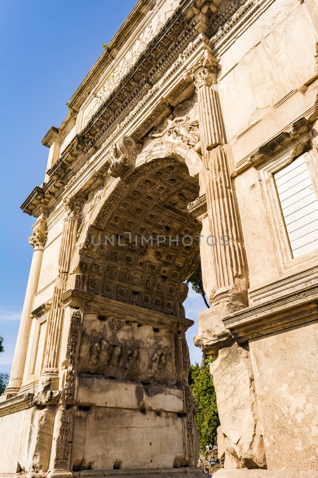 View of the Arch of Titus in Rome, Italy. The Arch of Titus is a Roman Triumphal Arch which was erected by Domitian.