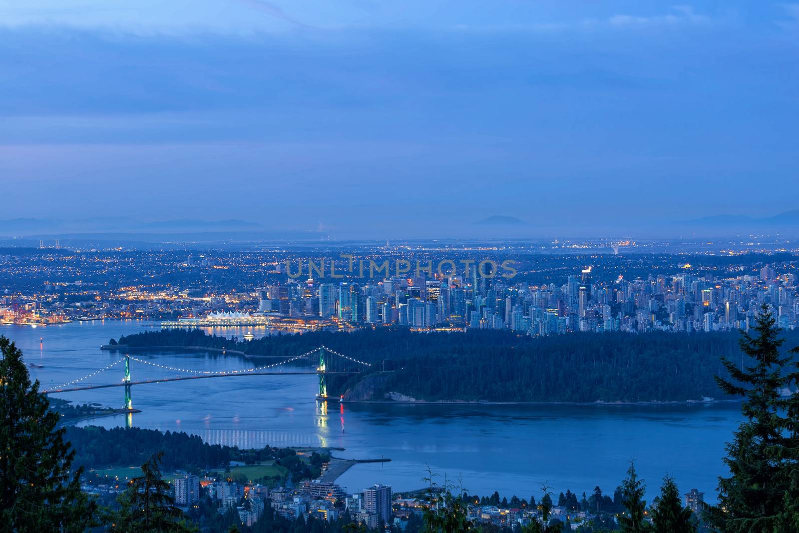 Vancouver British Columbia Canada cityscape by Stanley Park Lions Gate Bridge during early morning dawn blue hour 