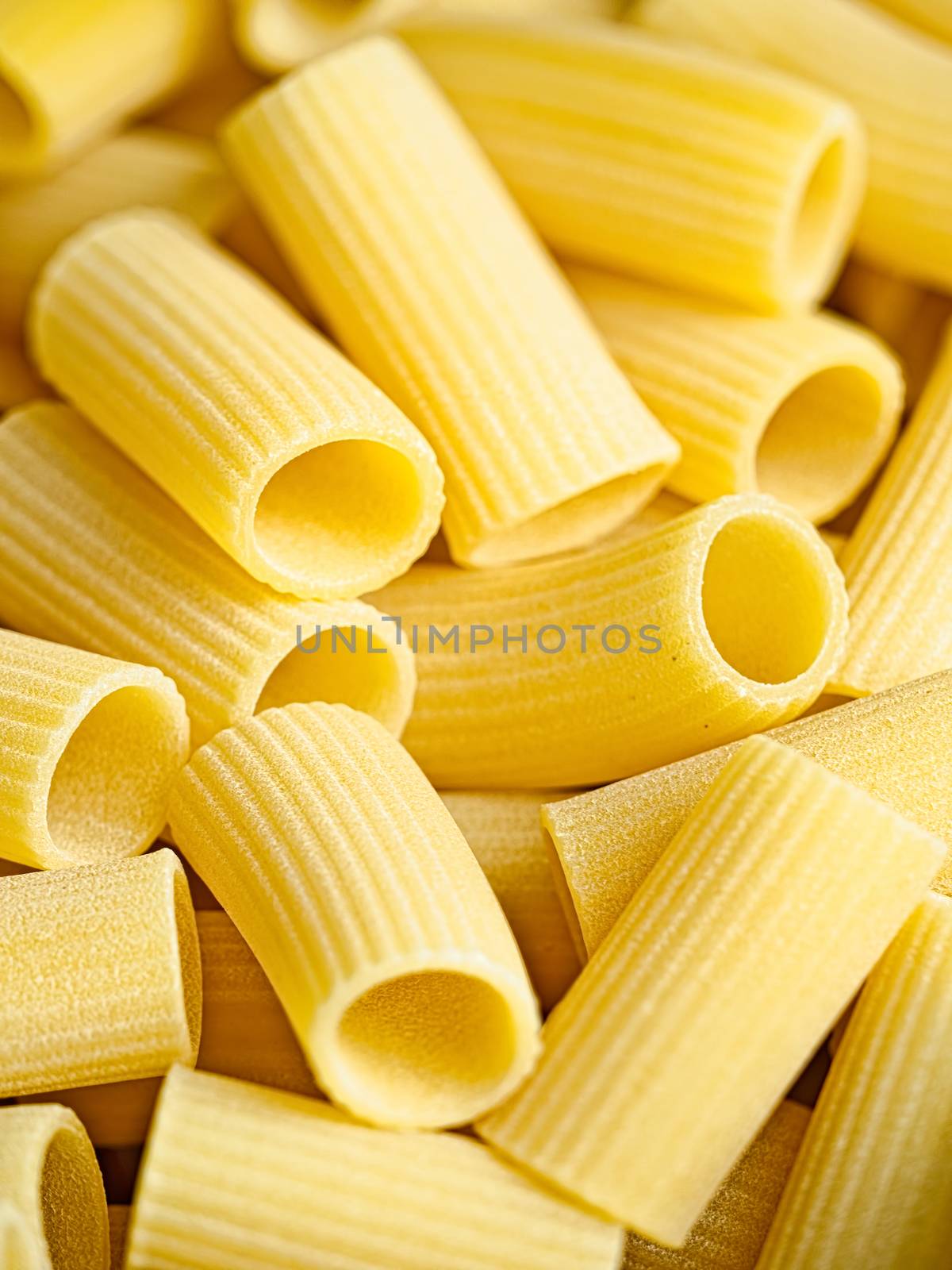 close up of uncooked italian rigatoni pasta