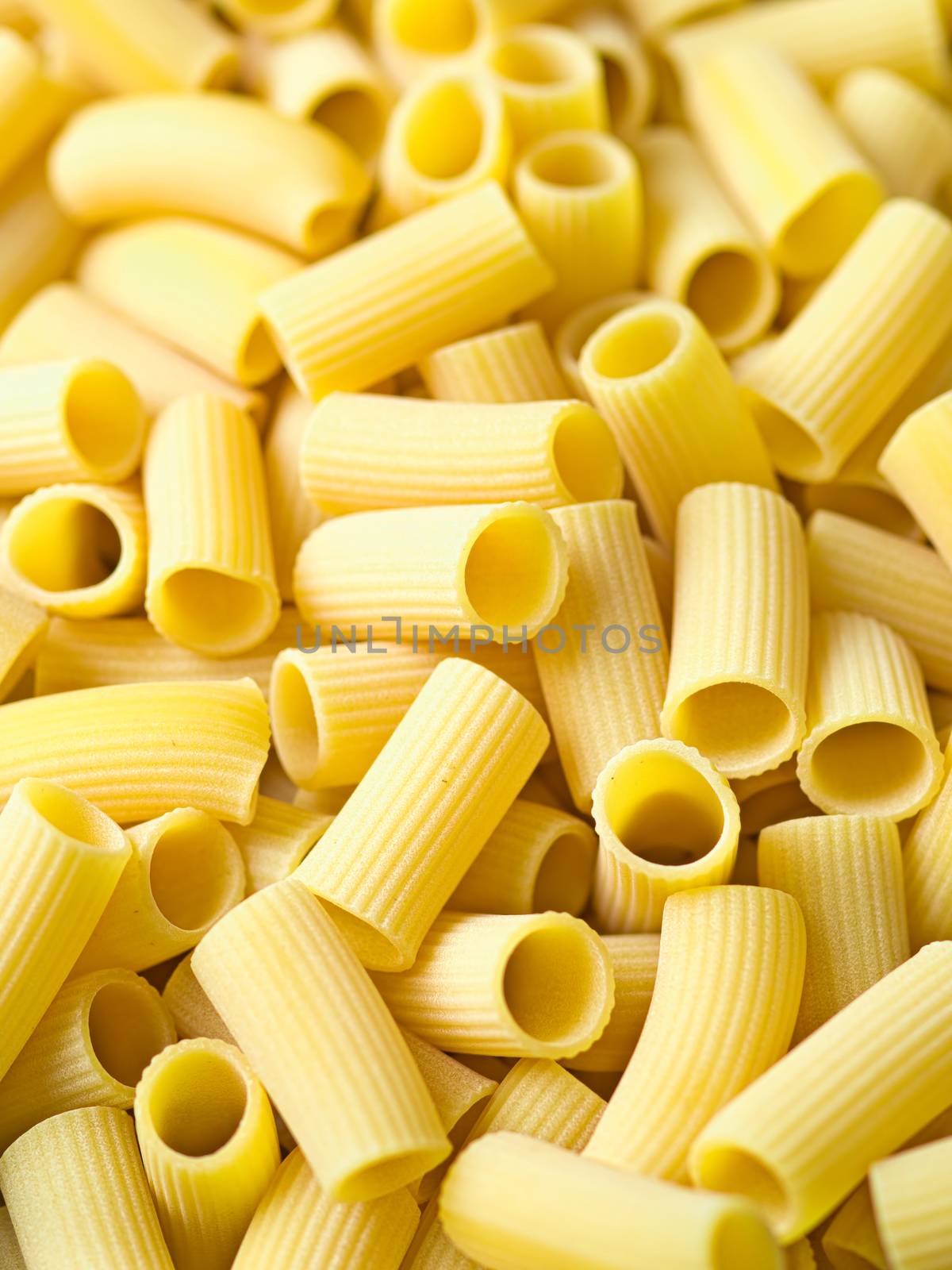close up of uncooked italian rigatoni pasta