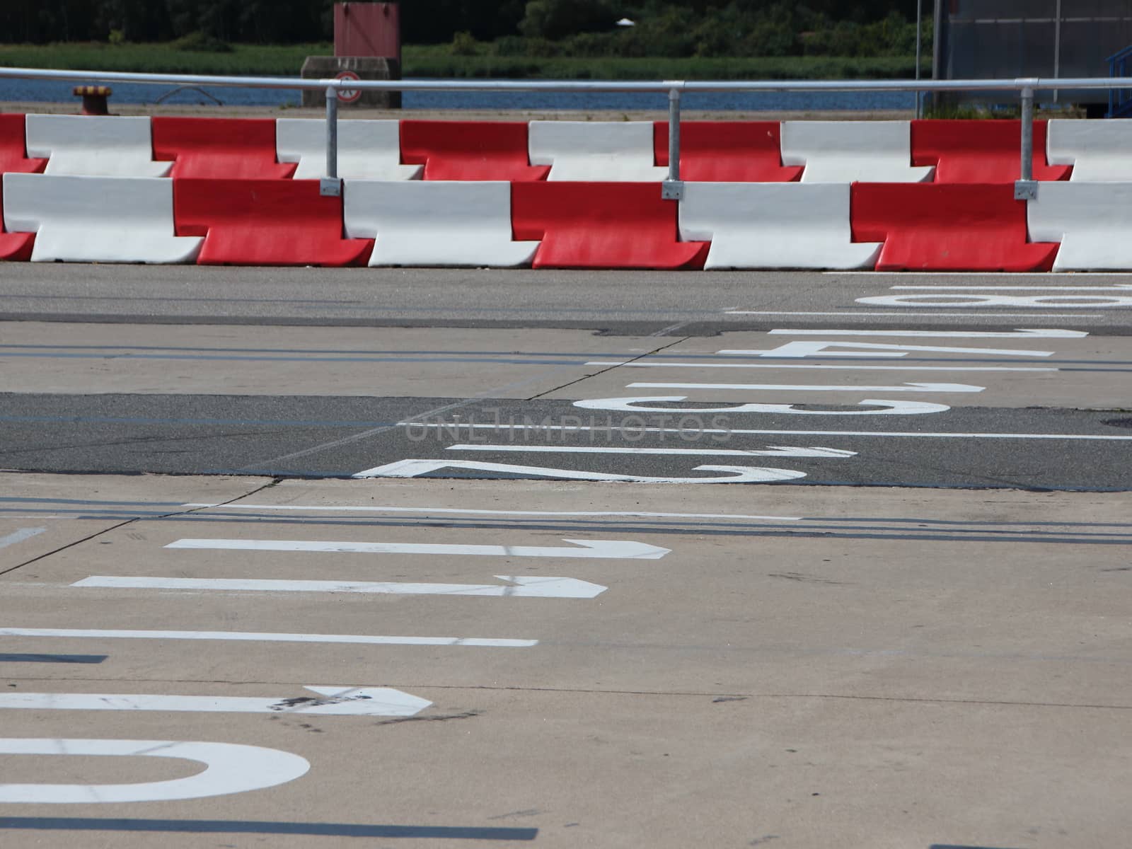 Car Lanes at Ferry Boarding with Striped Strong Crash Barriers by HoleInTheBox