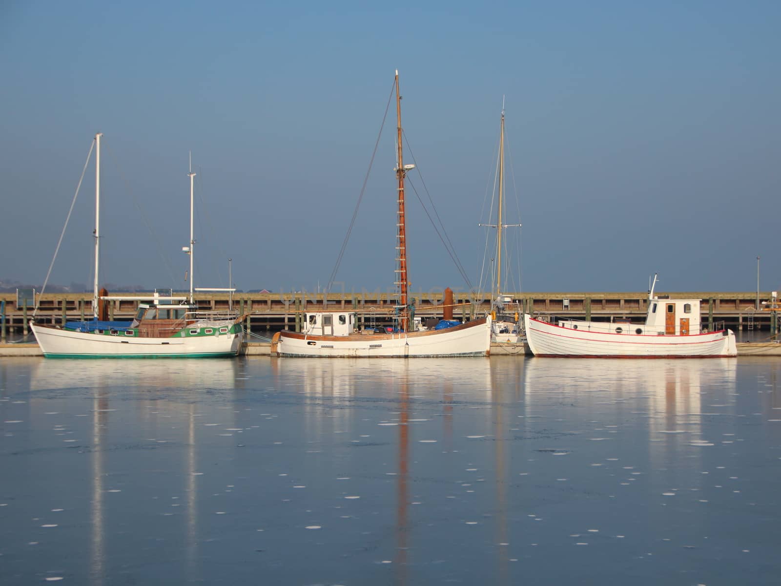 Three Boats in Frozen Harbor Salt Water at Wintertime