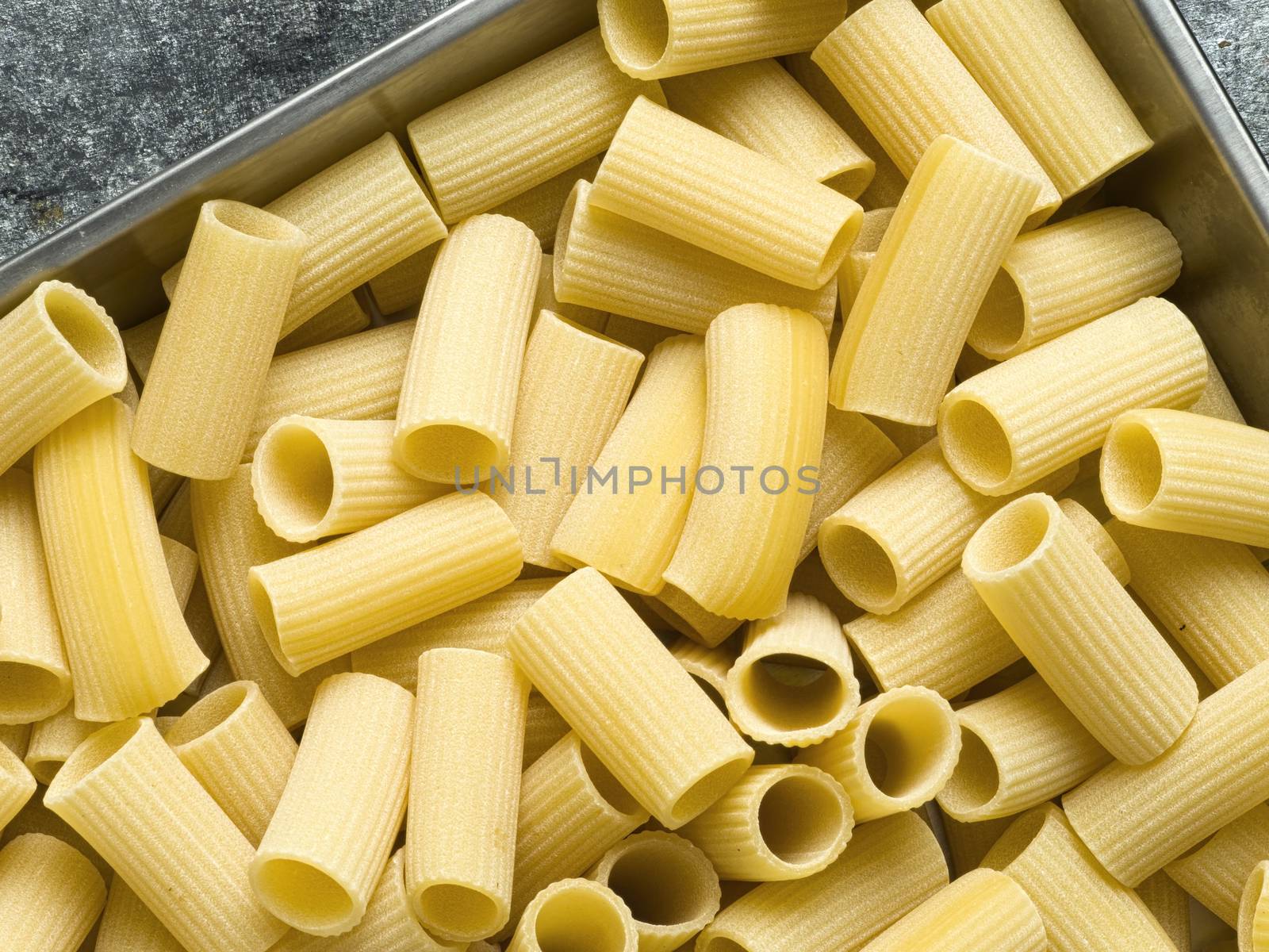 rustic uncooked italian rigatoni pasta by zkruger