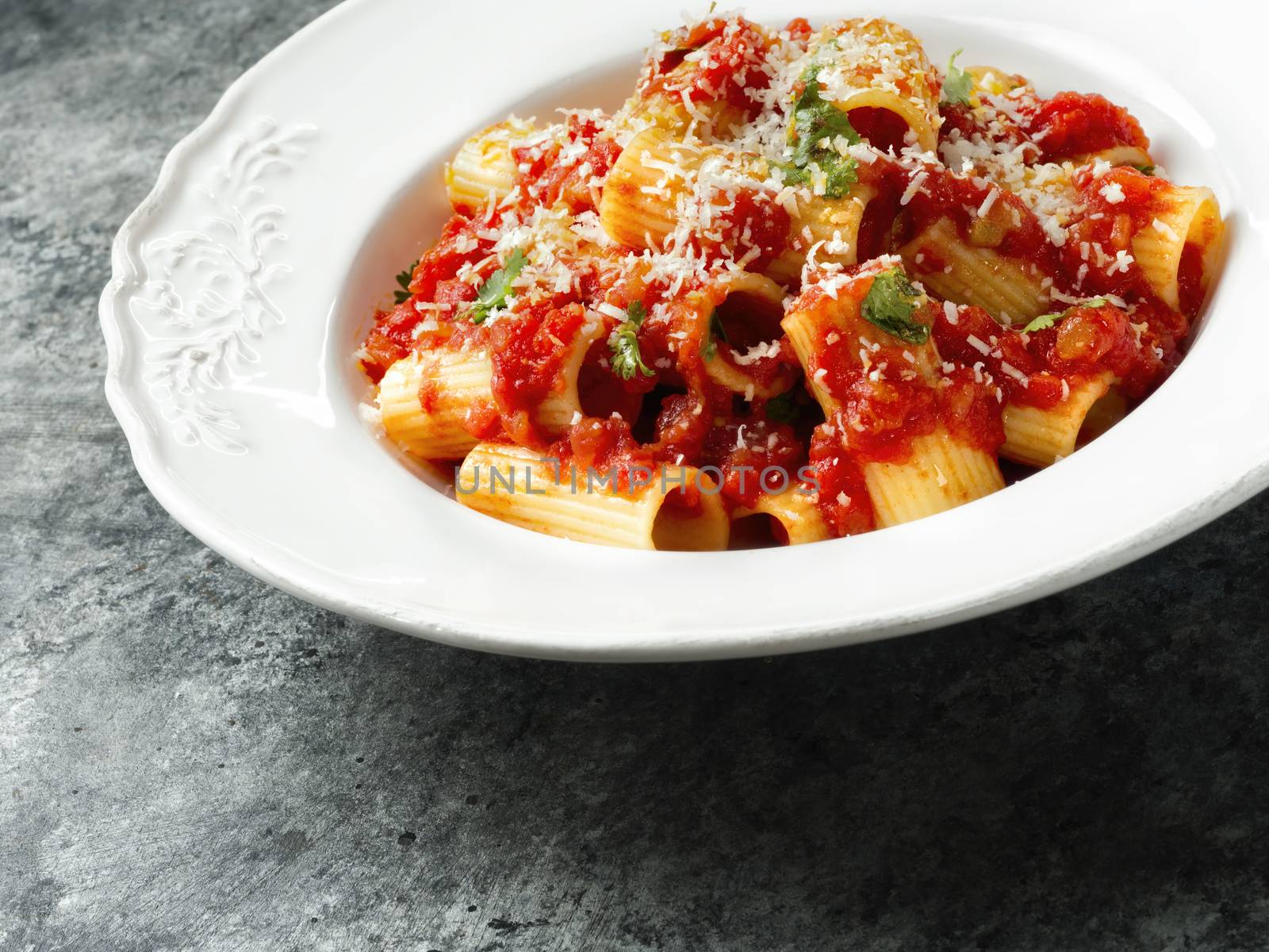 close up of rustic italian rigatoni pasta in tomato sauce