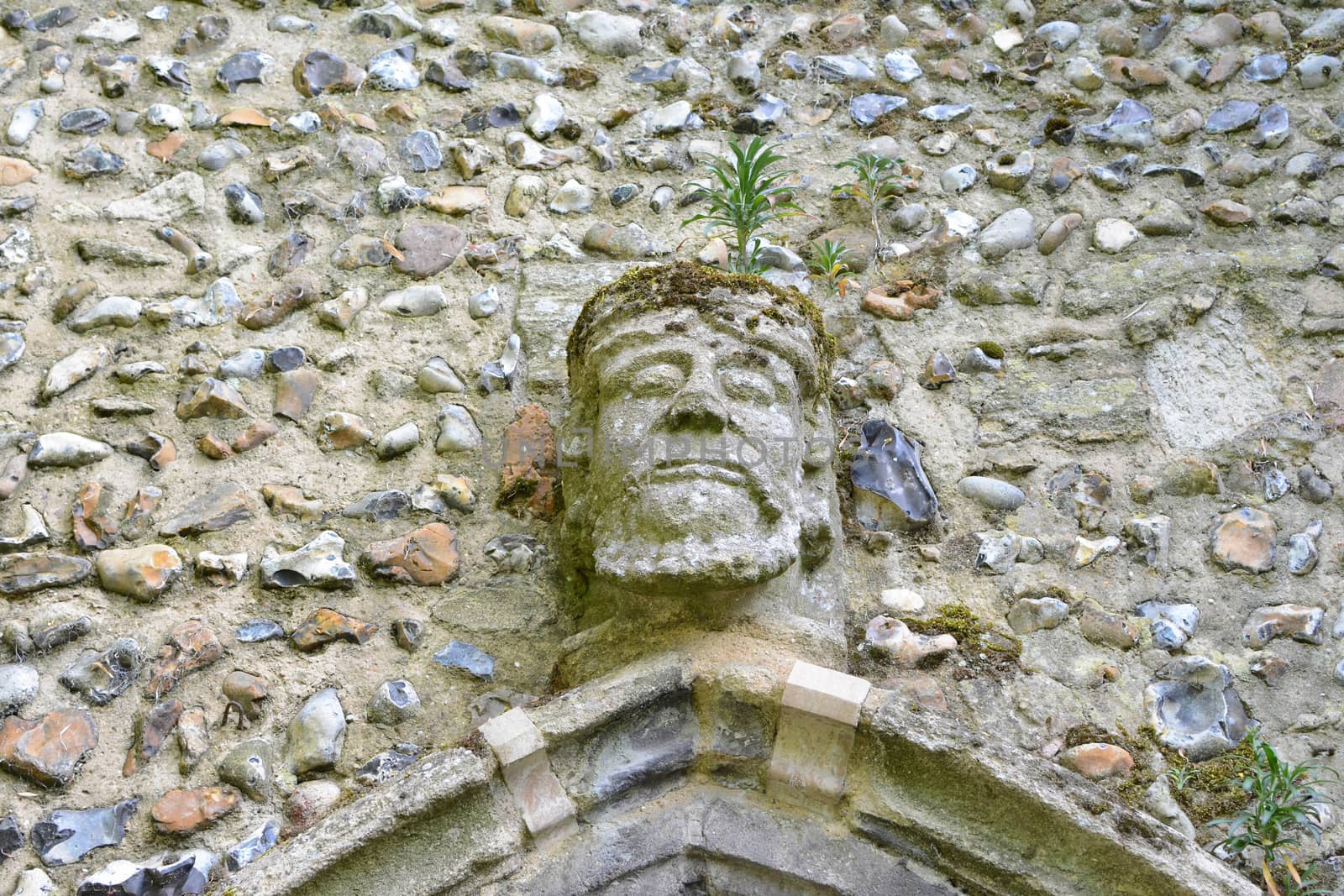 an old carved stone face on a wall