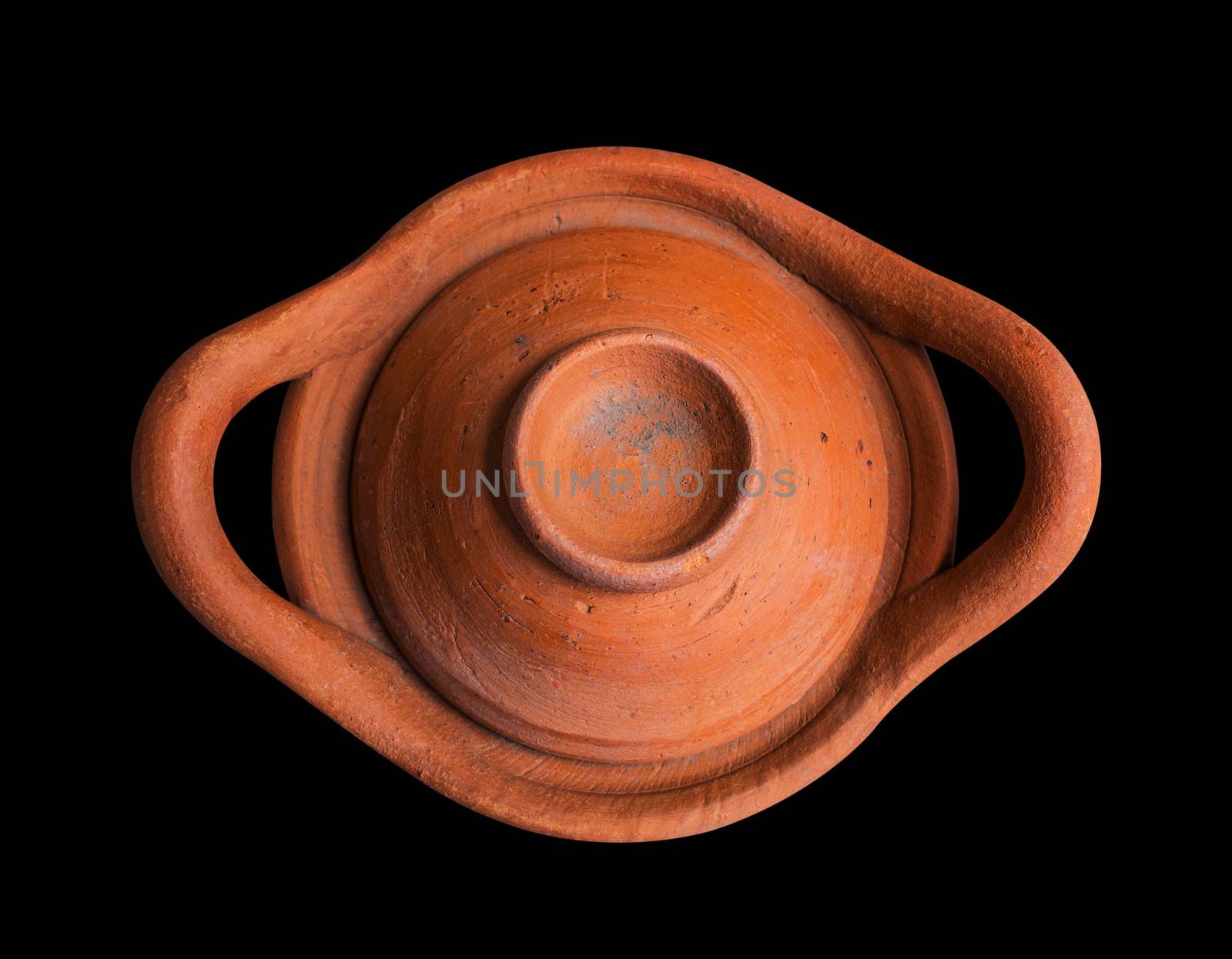 Old clay pot on a black background.