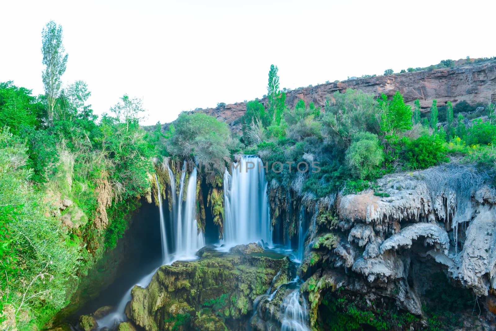 waterfall between rocks and trees