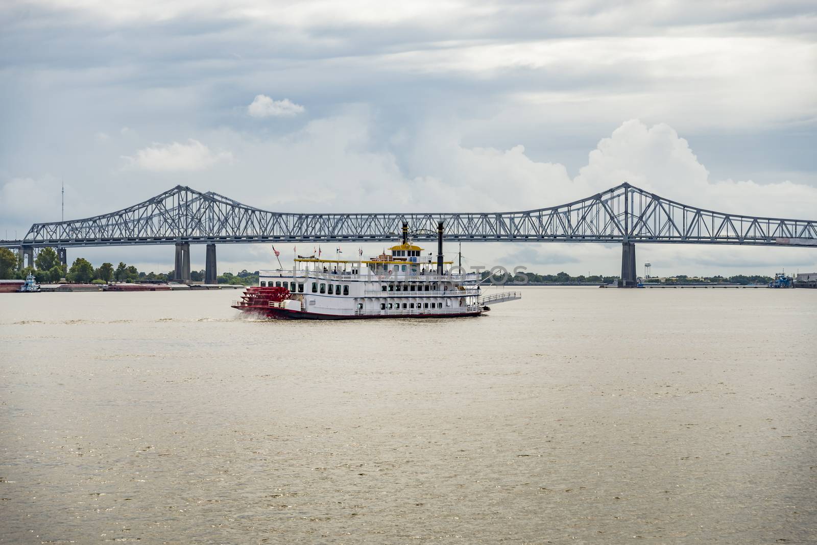 bridge over the Mississippi river with a boat in New Orleans, LA