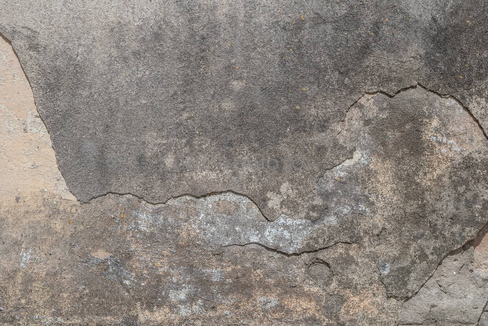 old chipped plaster on the concrete wall, gray texture, background by uvisni