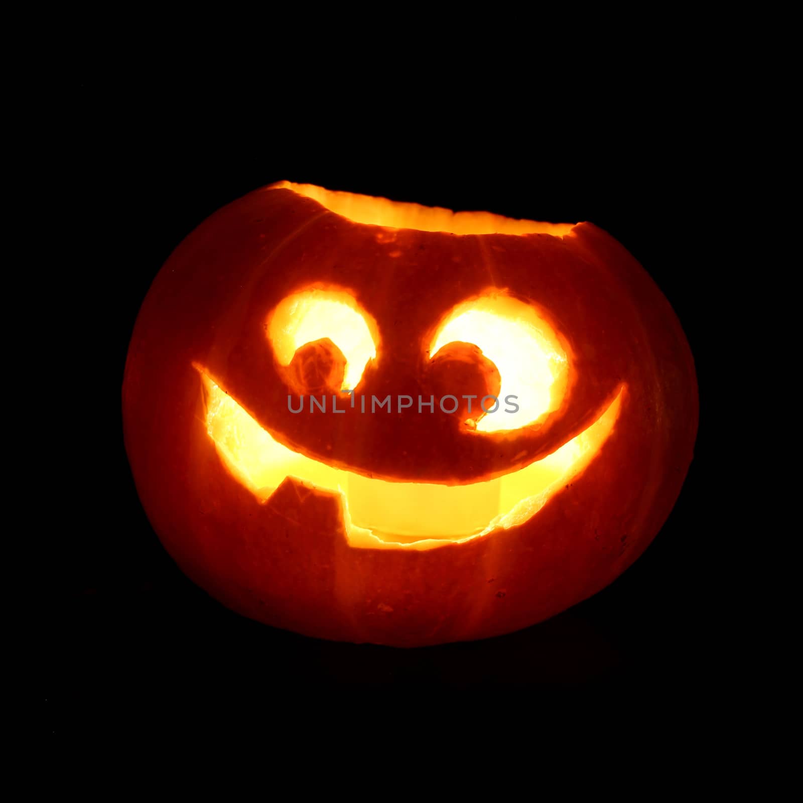 Illuminated cute halloween pumpkin isolated on black background