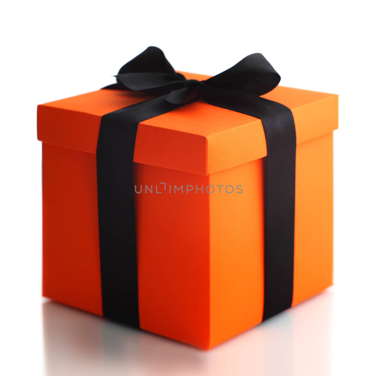 Decorated black and orange halloween gift box isolated on white background with reflection