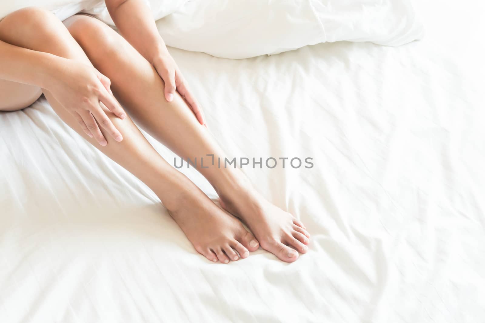 Closeup woman legs on white bed, beauty and skin care concept, s by pt.pongsak@gmail.com