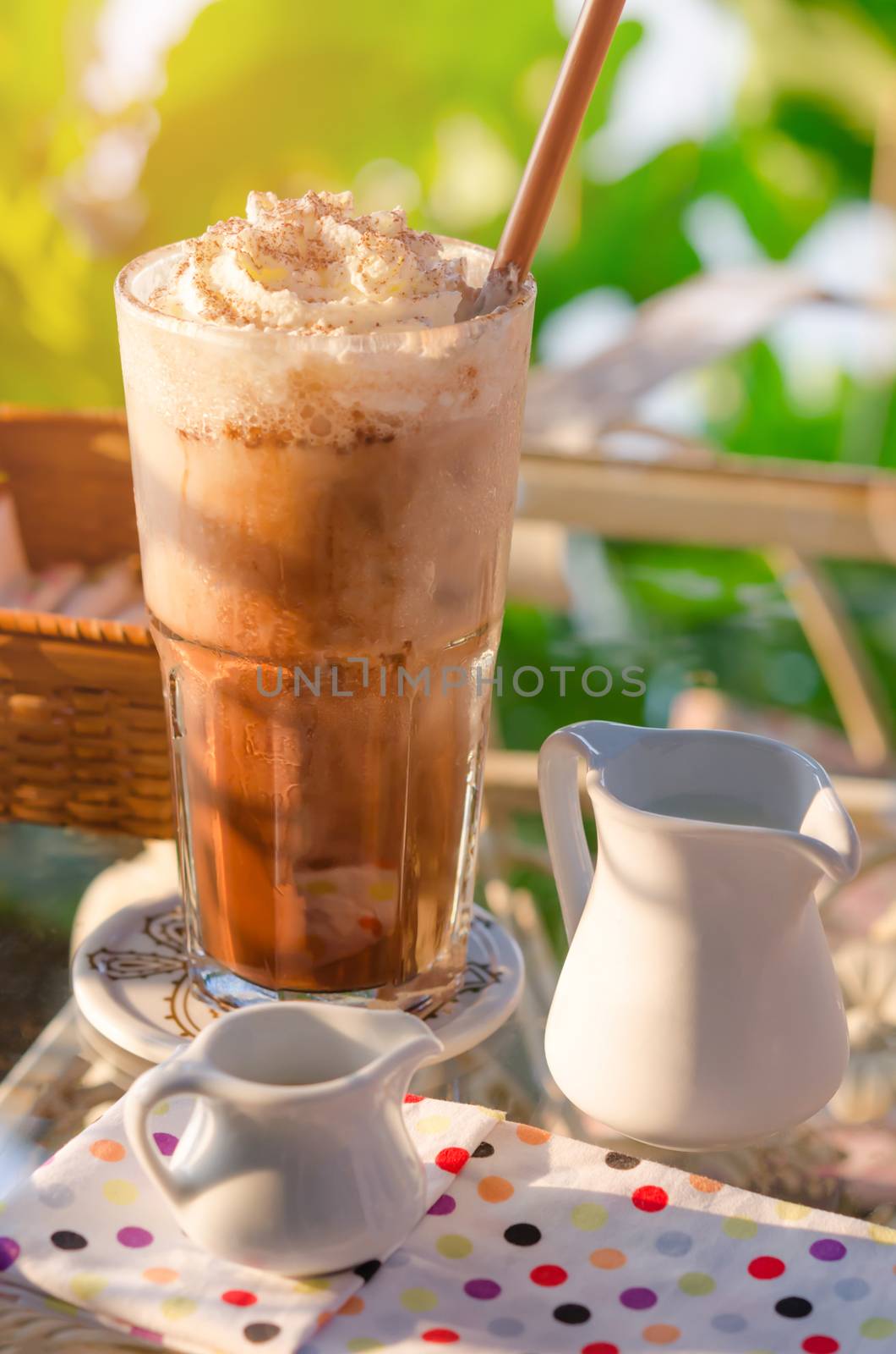 Iced coffee with whipped cream and sprinkle cocoa