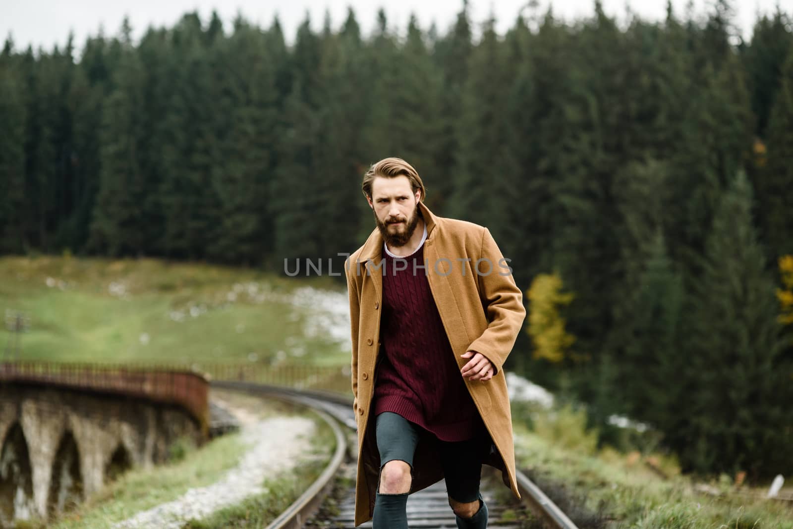 brutal bearded man walks on the tracks by Andreua