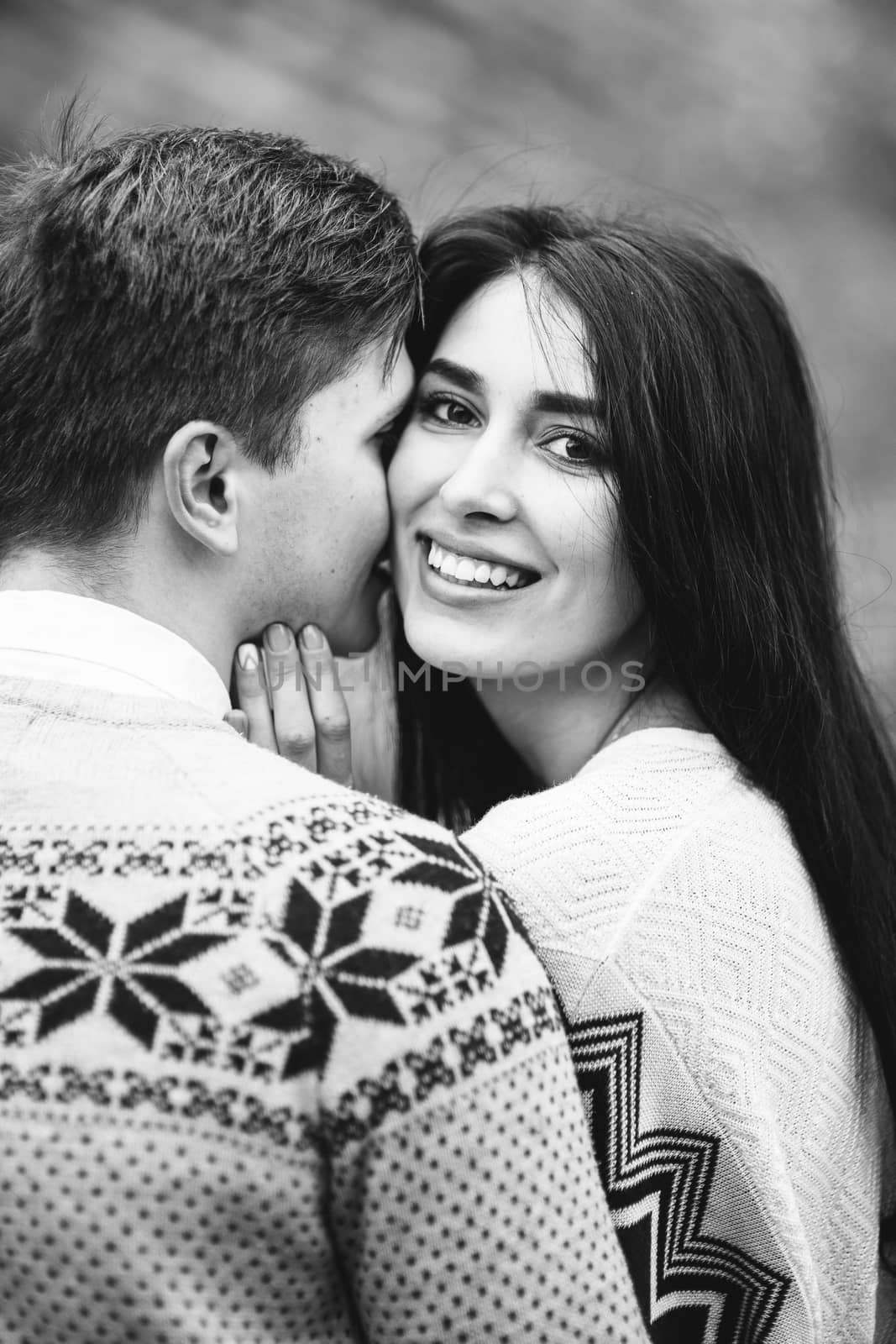 guy and girl in warm sweaters walking along a mountain river, love story