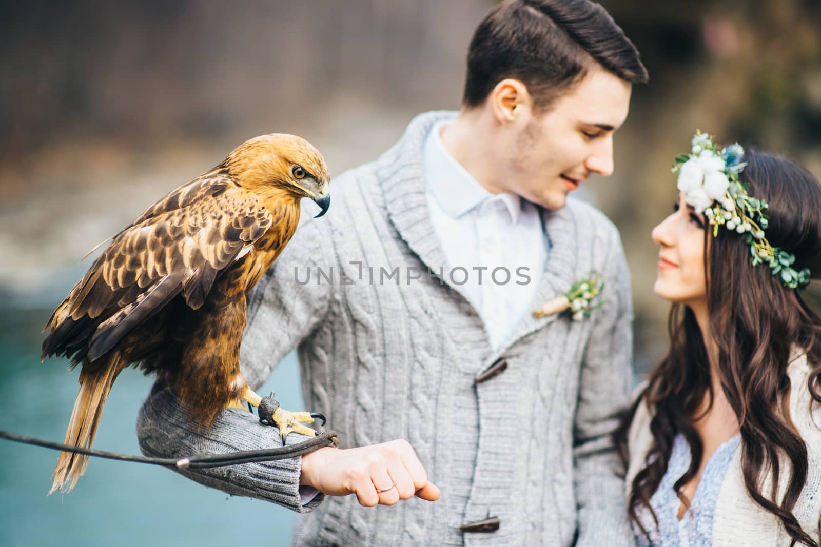 Сouple of newlyweds in the Carpathian waterfall, a wedding walk