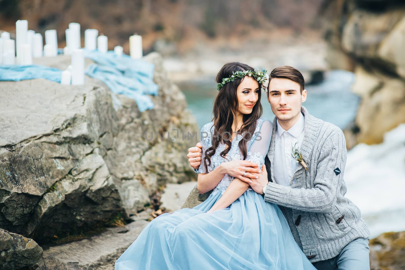 Сouple of newlyweds in the Carpathian waterfall, a wedding walk