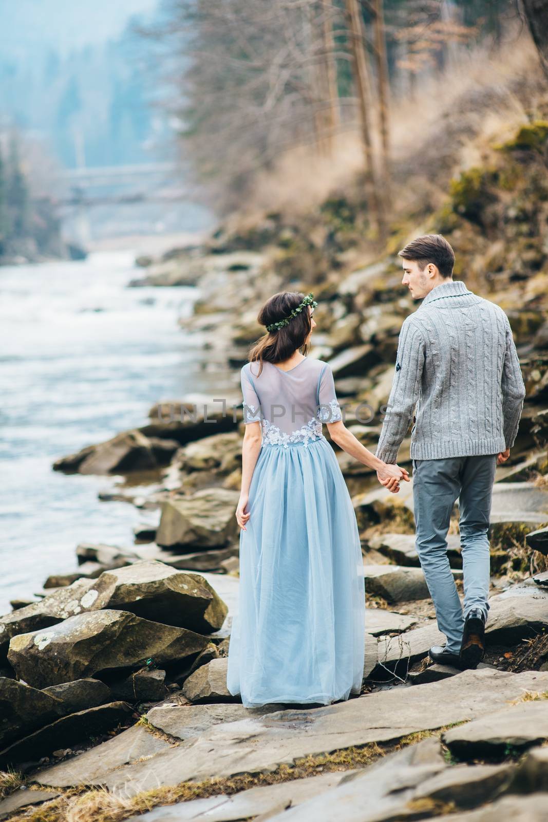 Сouple of newlyweds in the Carpathian waterfall, a wedding walk by Andreua