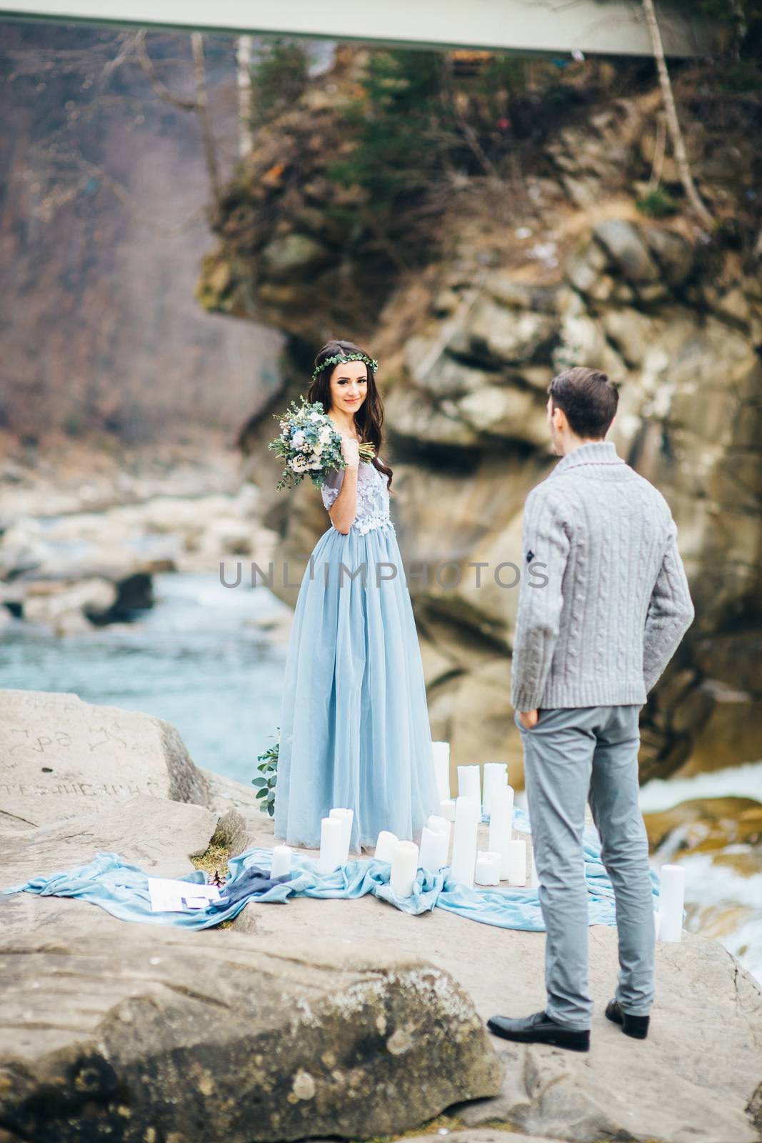 Сouple of newlyweds in the Carpathian waterfall, a wedding walk